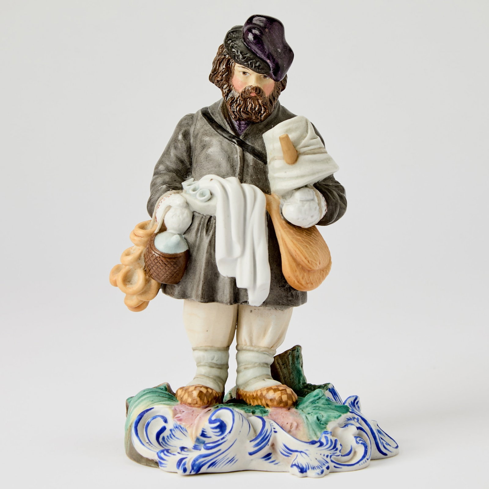 Russian Porcelain Figure of a Bagel and Sbiten Vendor: Gardner Manufactory, Verbilki, 1840s-1850s Height 7 1/2 inches (19 cm). Another version of this model is illustrated in Gardner: XVIII - XIX: Porcelain Plastic Arts from Private Collections & Mos