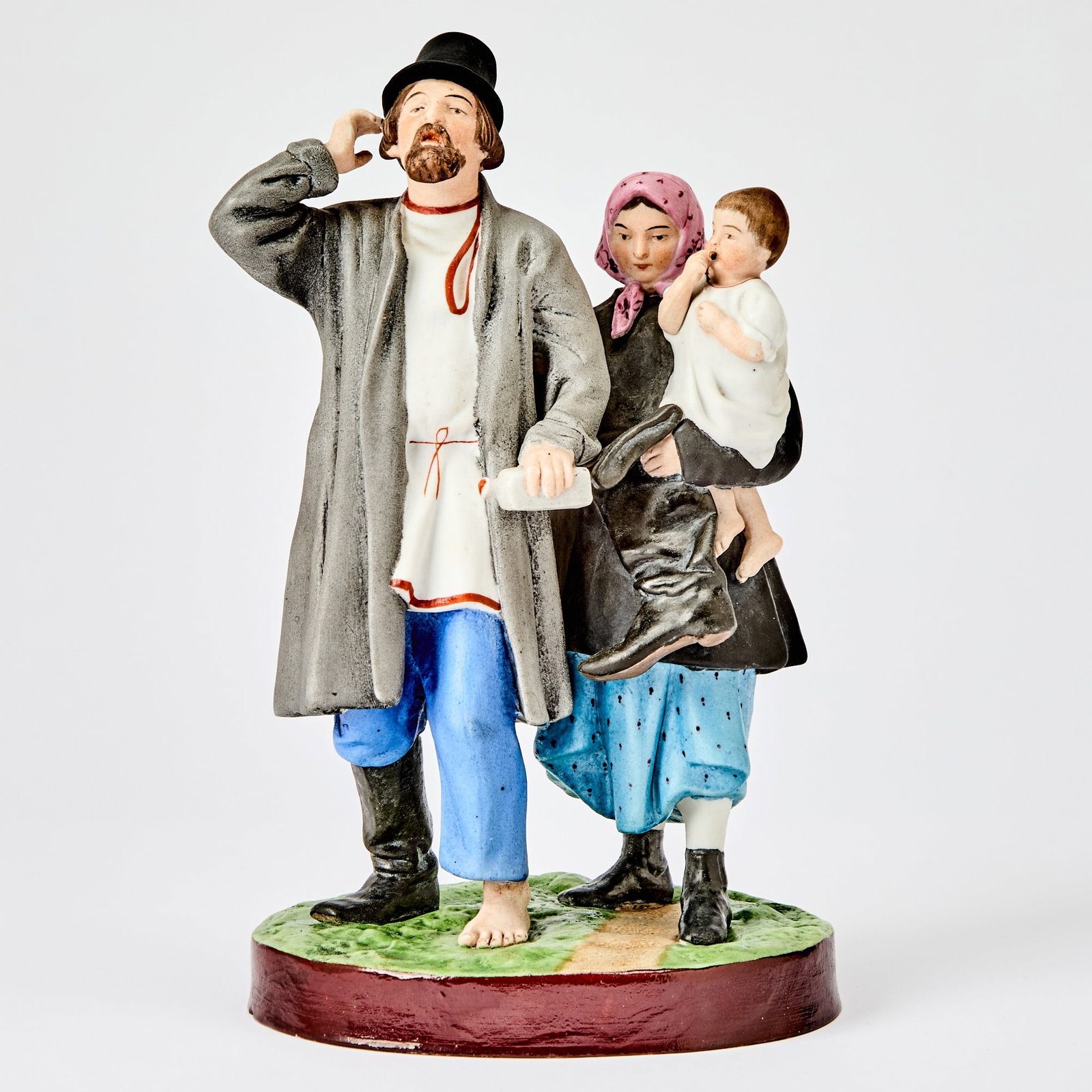 Russian Porcelain Group of Peasant Woman with a Child Leading Her Husband Home from the Tavern: Gardner Manufactory, Verbilki, 1870-1880 Height 9 7/8 inches (25 cm). Another version of this model is illustrated in Gardner: XVIII - XIX: Porcelain Plastic Arts from Private Collections & Mosco