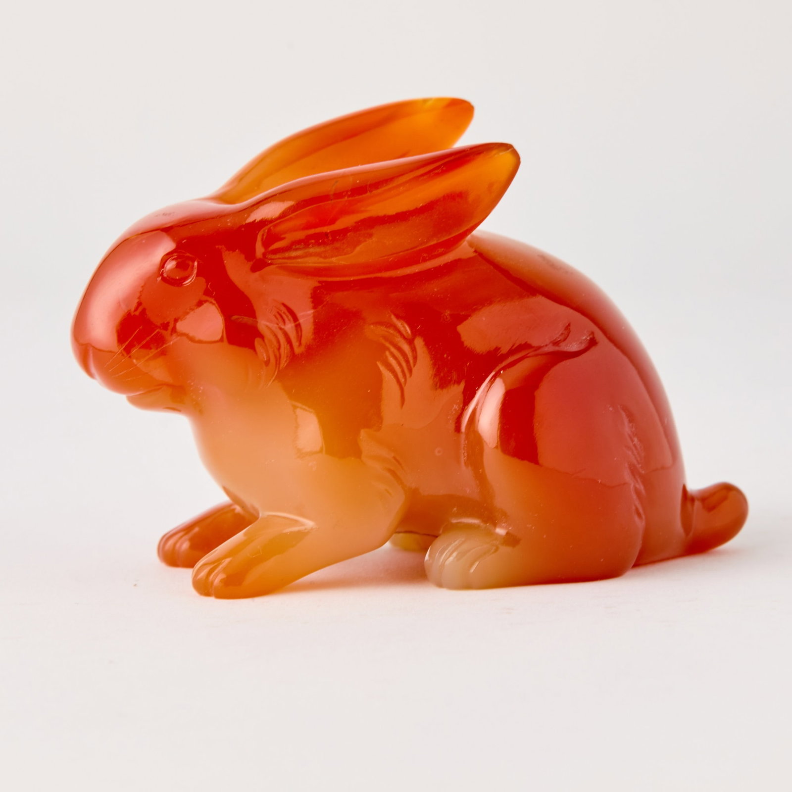 Chinese Carved Carnelian Rabbit Qing Dynasty: The figure poised in a recumbent position. (Length 4 inches) Previously Rare Art, with label.