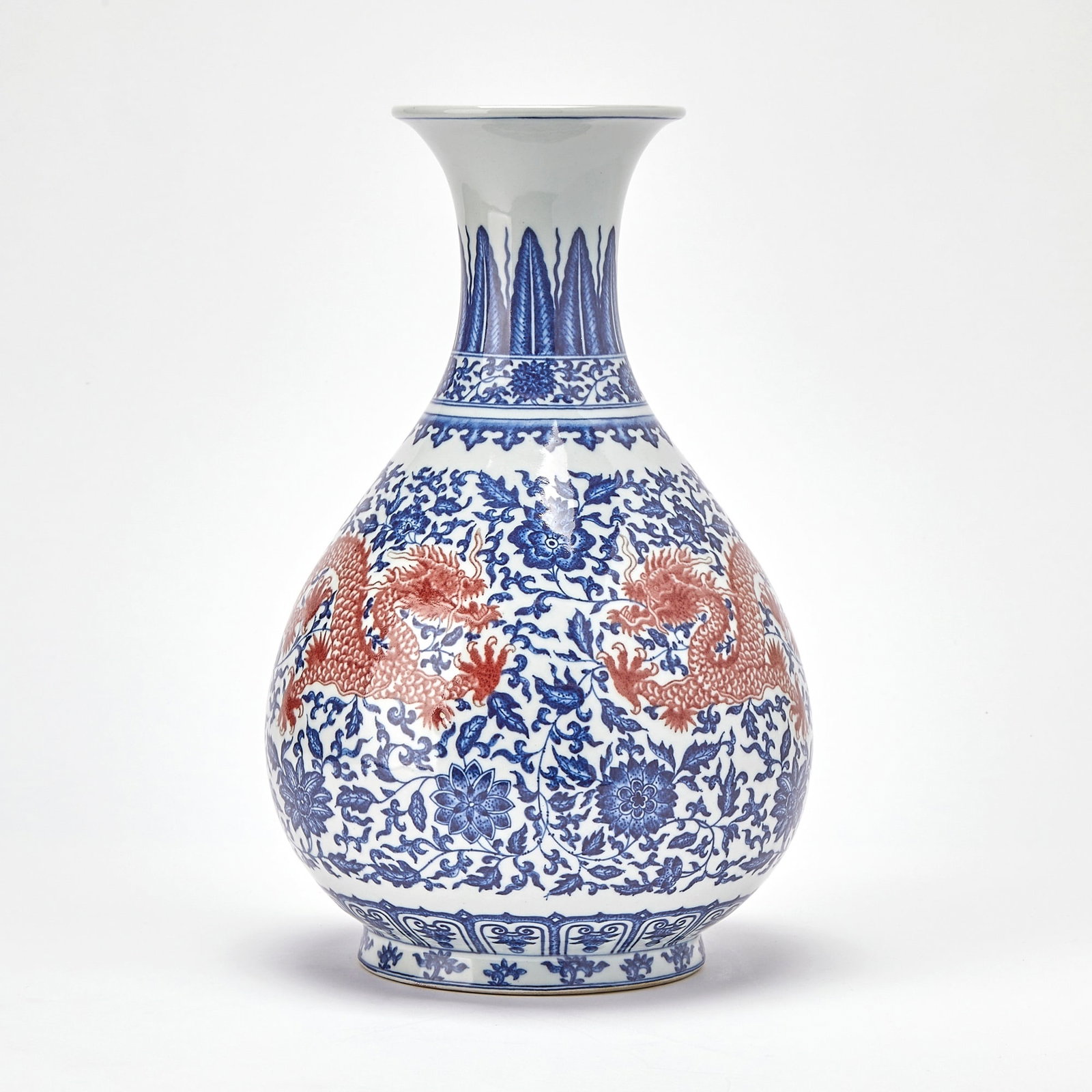 Chinese Blue and White Porcelain Red Dragon Vase, Yuhuchun 20th century: Decorated with a pair of confronting dragons writhing among blossoms borne on scrolling leafy vines, all between decorative borders at the neck and base. (Height 14 1/2 inches)