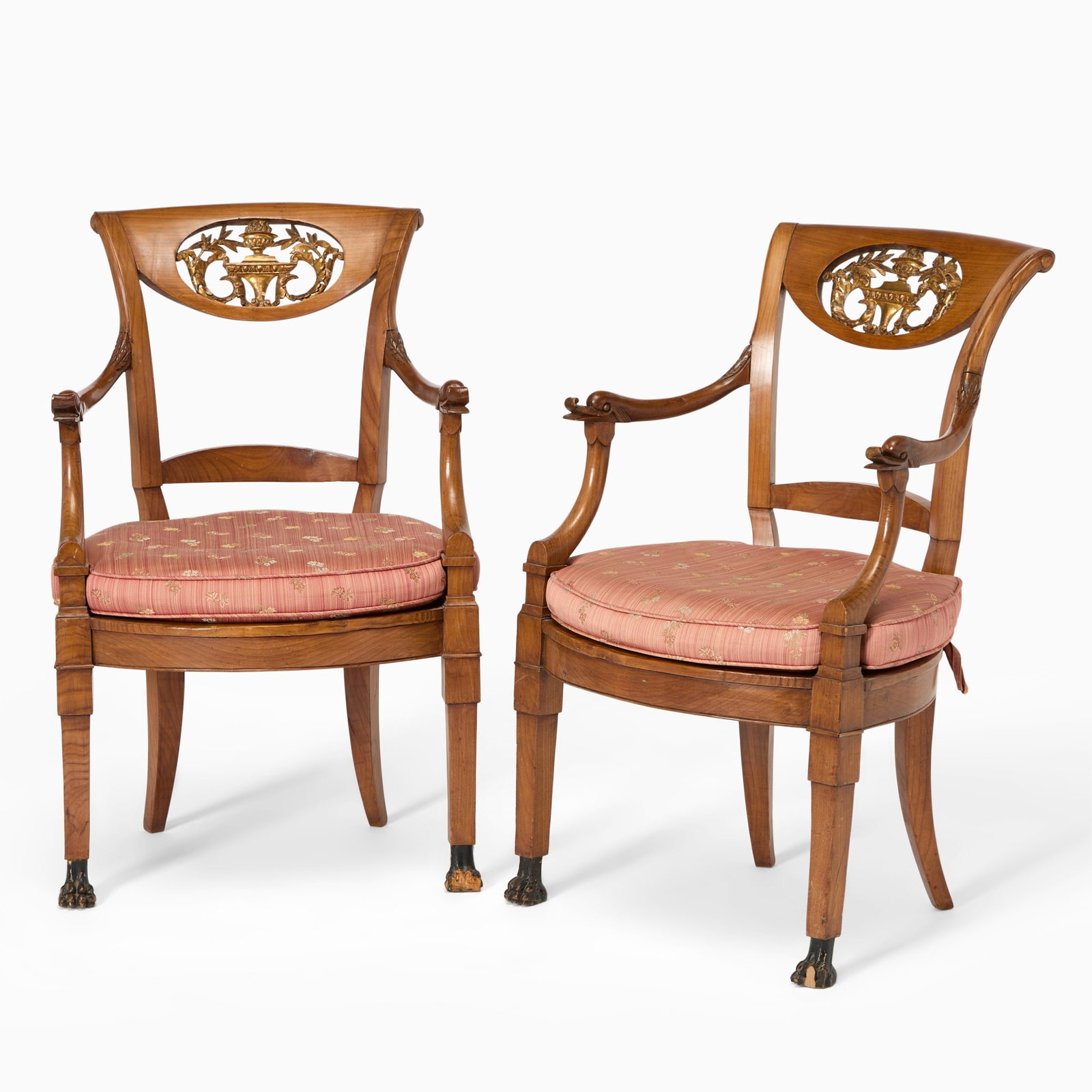Pair of Continental Neoclassical Parcel-Gilt Fruitwood Fauteuils: Early 19th centuryHeight 36 inches, width 23 inches, depth 18 1/2 inches. With previous restorations, one caned seat broken, some age cracks to veneers, shrinkage cracks at lines of construction,