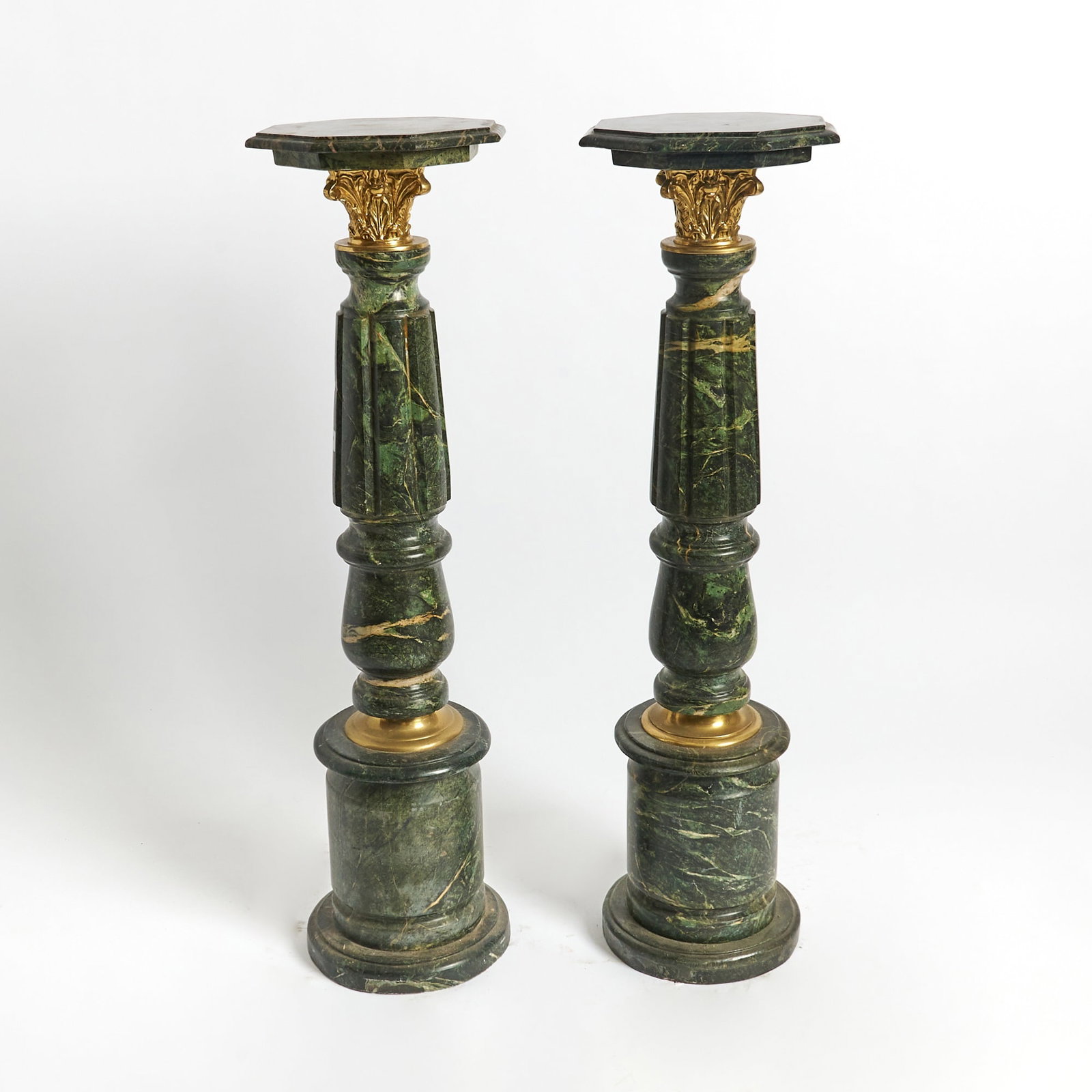 Pair of Gilt-Bronze-Mounted Green Marble Pedestals: Height 42 1/2 inches, diameter of top 12 1/2 inches.