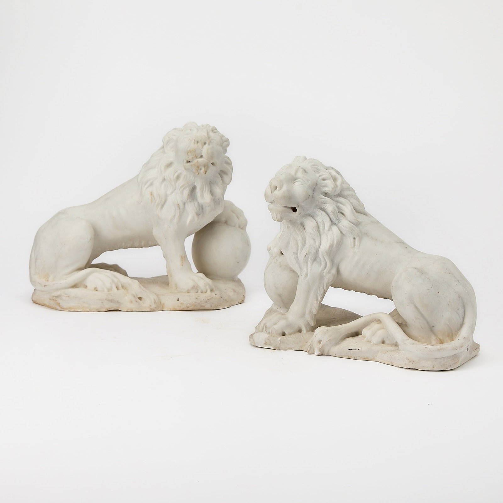 Pair of Carved Carrara Marble Figures of Lions: 19th CenturyHeight 9 1/2 inches, width 13 inches.