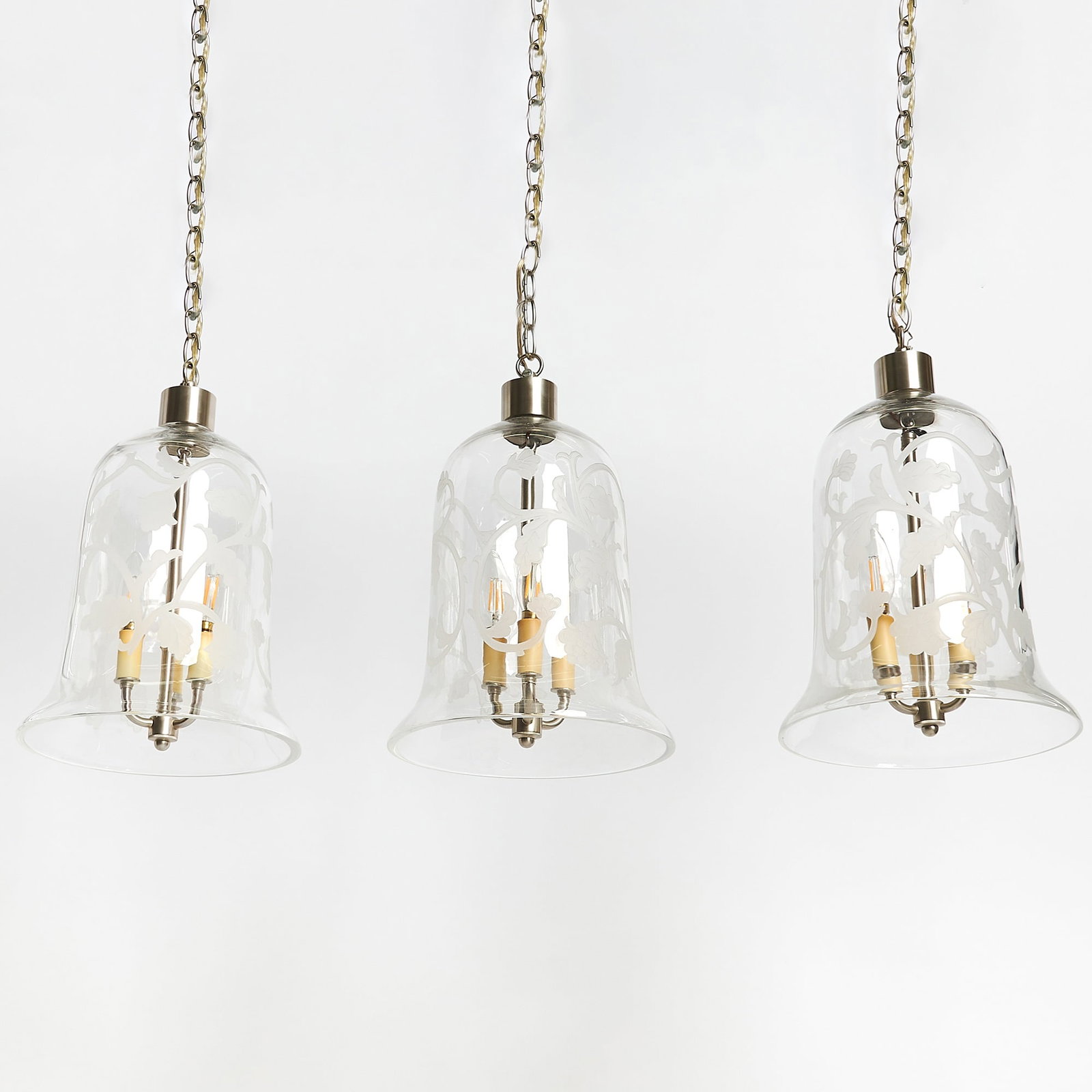 Set of Three Glass "Arabesque" Bell Jar Lanterns: Height 15 inches, diameter 10 3/4 inches.