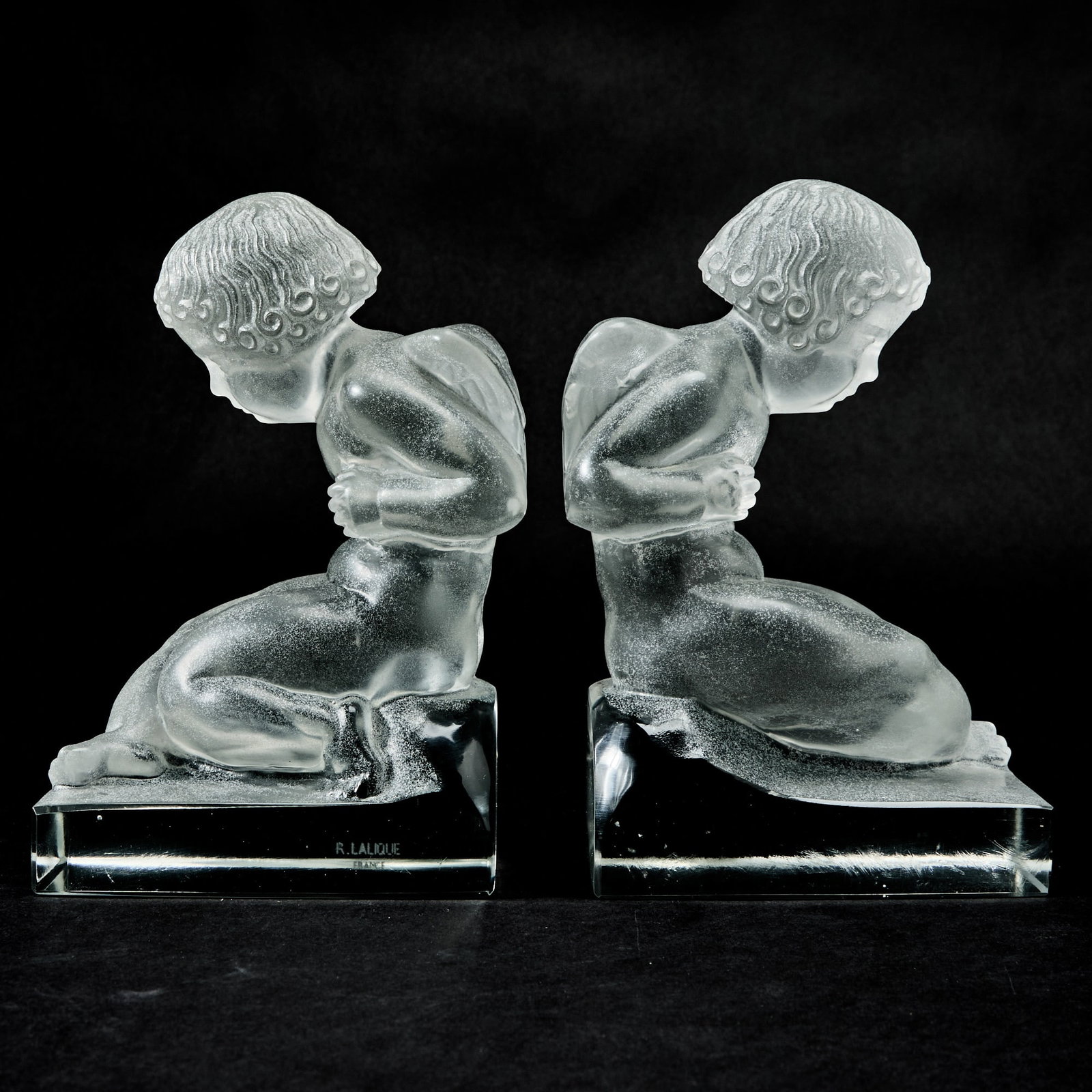 Pair of Lalique Molded Glass Cupid Bookends: Amour: Marked R Lalique. Height 7 1/4 inches. generally good condition