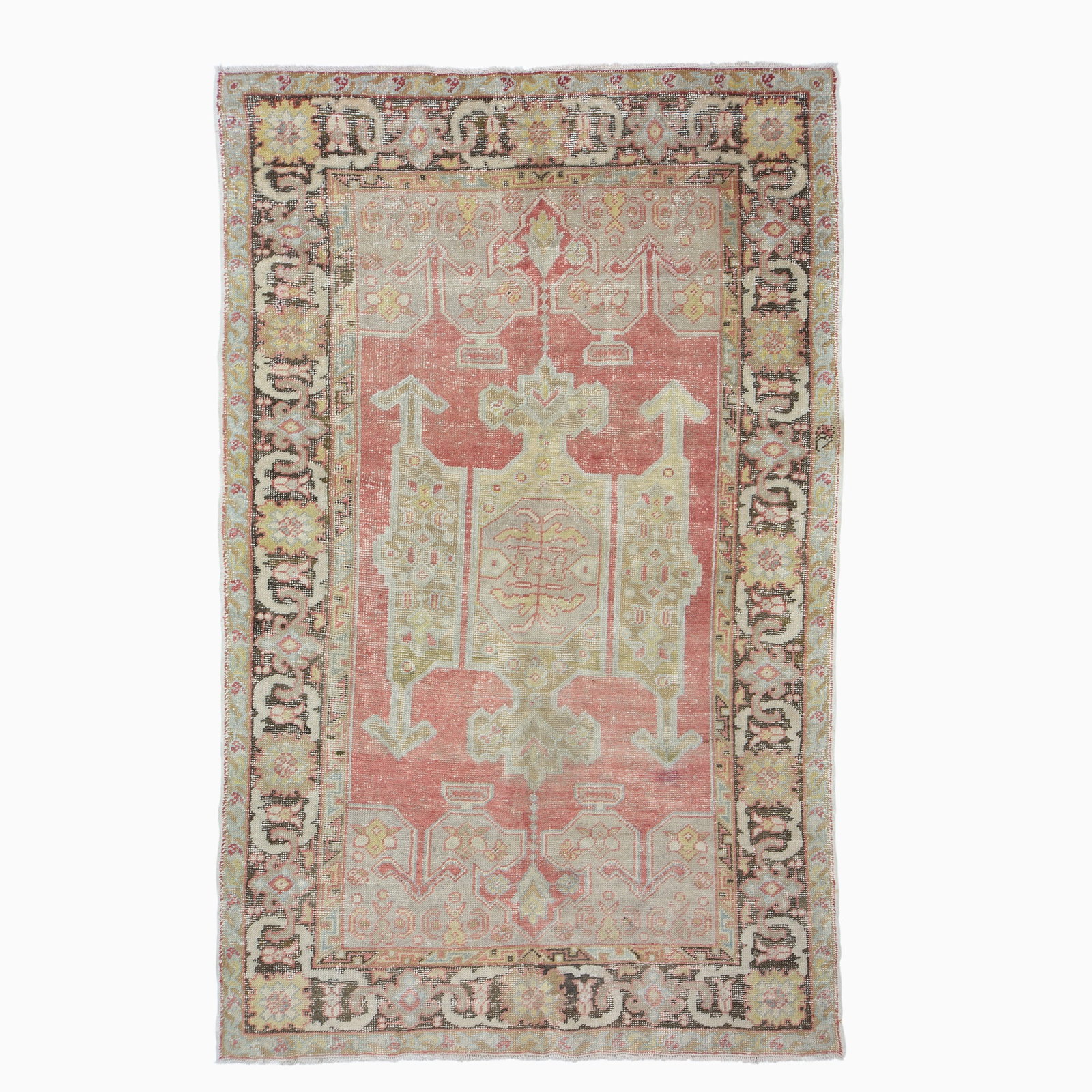 Ghiordes Rug: West Turkey, 2nd 1/4 20th CenturyThe central geometric medallion on the pale madder field is within a dark chocolate palmette and vine border. (7' 11" x 5' 0") Even overall wear, small re-piled