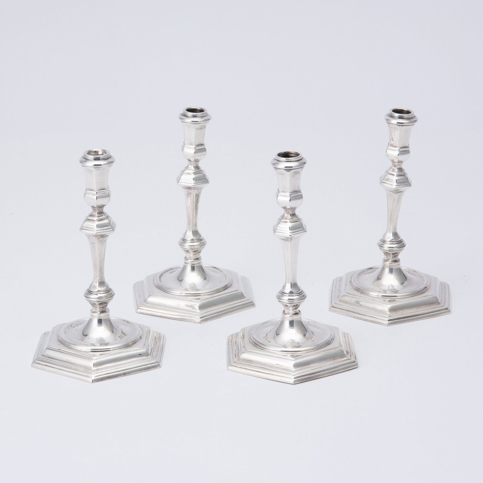 Set of Four English Sterling Silver Tapersticks: James Robinson, London, 1960s Each faceted knopped stem on a hexagonal base. Height 4 1/4 inches (11 cm), total approximately 17 ounces.