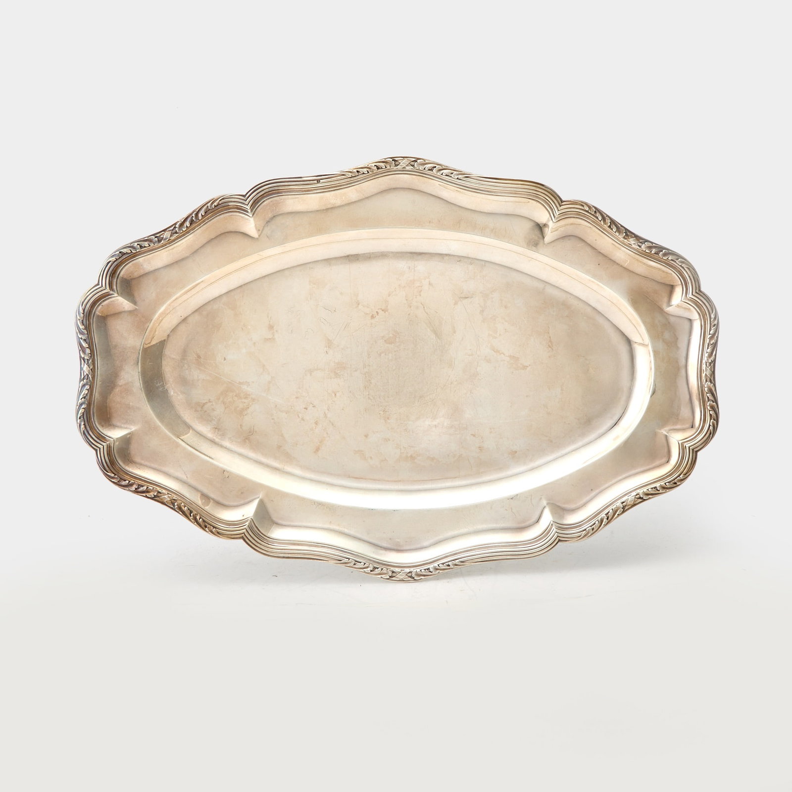 French Puiforcat Silver Platter: Paris, early 20th century Shaped oval with tied reeded and foliate rim. Length 17 3/4 inches (45 cm), approximately 32 ounces.