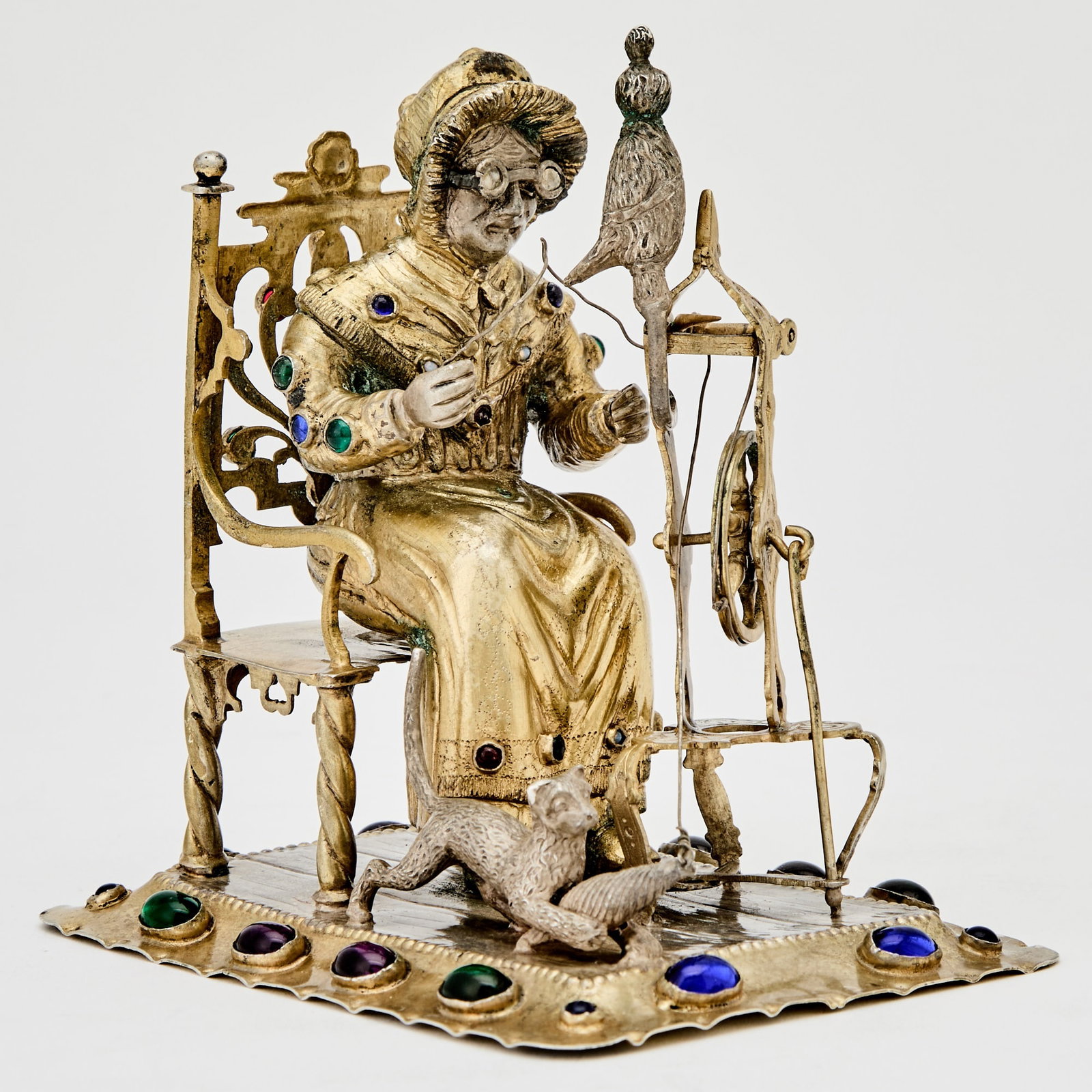Continental Gem-Set Silver Figure of a Woman at a Spinning Wheel: Early 20th century Height 5 1/4 inches (13 cm), length 5 inches (13 cm). approximately 13 ounces, all in.
