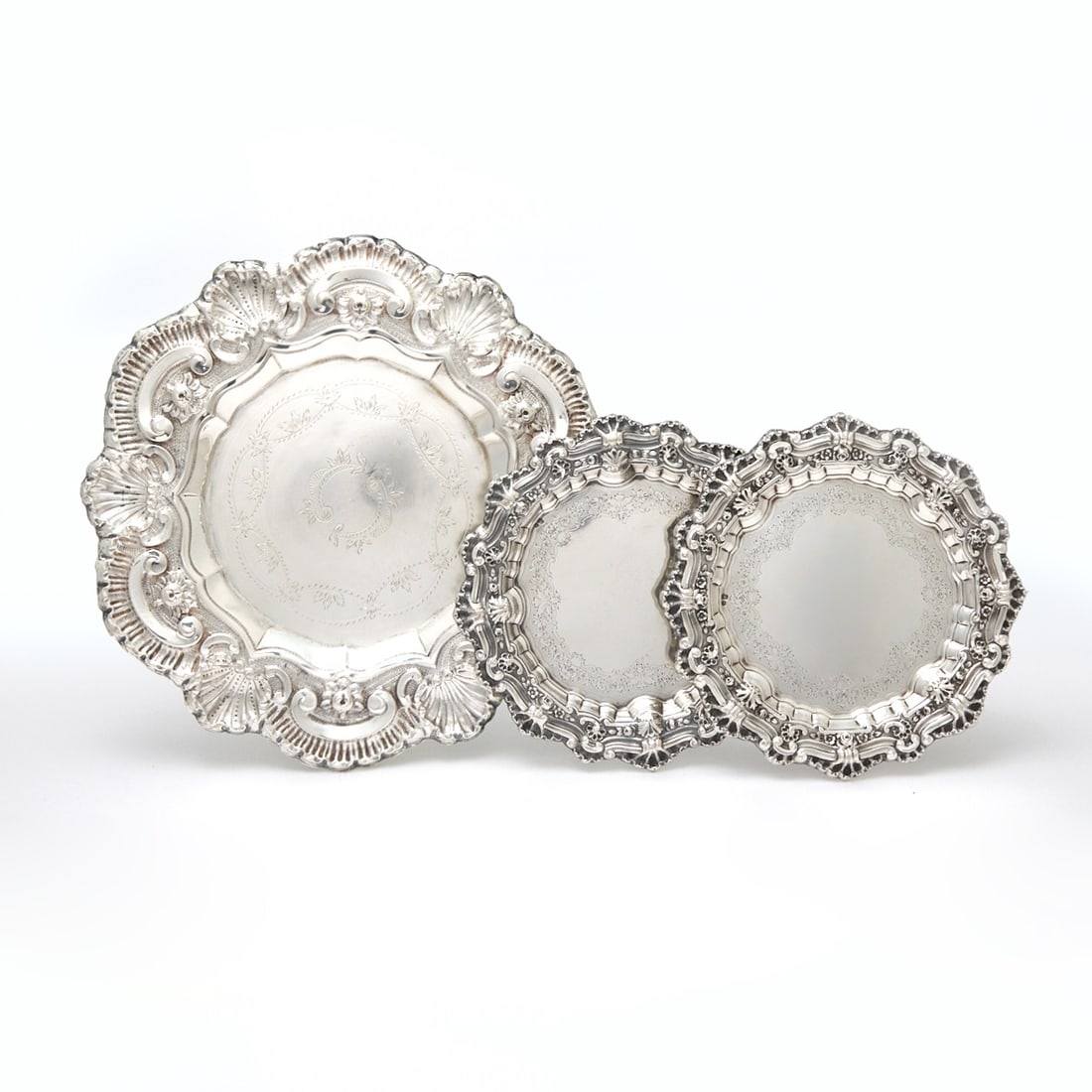 Pair of Portuguese Silver Bottle Coasters and Larger Salver: 20th Century Each shaped circular with shell and floral border. Diameter of pair 8 1/4 inches (21 cm), diameter of larger 13 inches (33 cm), total approximately 25 ounces.