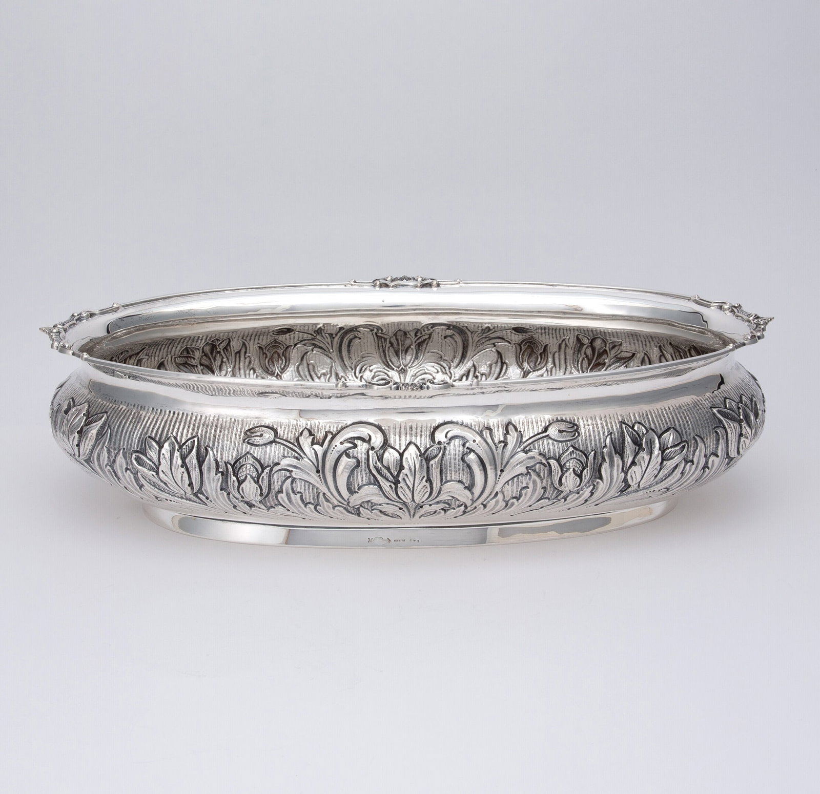 Italian Sterling Silver Jardiniere: Manzzucato, Milan, late 20th century Oval, the body chased with foliate scrolls on a textured ground. Height 4 1/4 inches (11 cm), length 17 inches (43 cm), approximately 52 ounces.