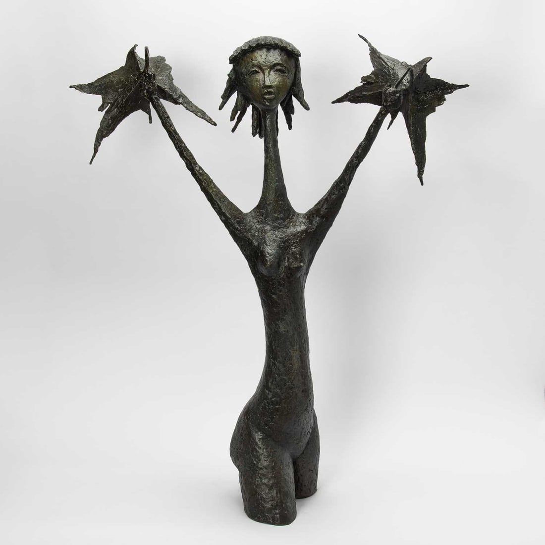 Angel Botello: Puerto Rican, 1913-1986 Girl With Umbrella, circa 1965-70 Signed Botello and numbered #2 Bronze 40 x 34 x 12 inches (101.6 x 86.4 x 30.5 cm) Provenance: Private collection, New Mexico The