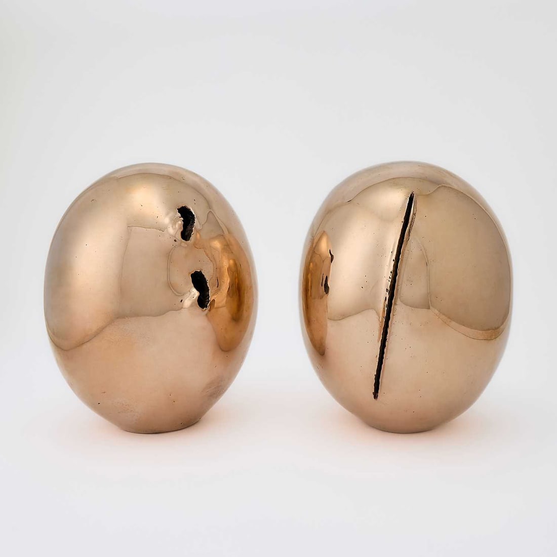 Lucio Fontana: Argentinian/Italian, 1899-1968 Concetto Spaziale, Natura, 1967 Incised with artist's signature Fontana on the reverse of each and numbered 143/500 on underneath each Polished brass, in two parts 10 1/
