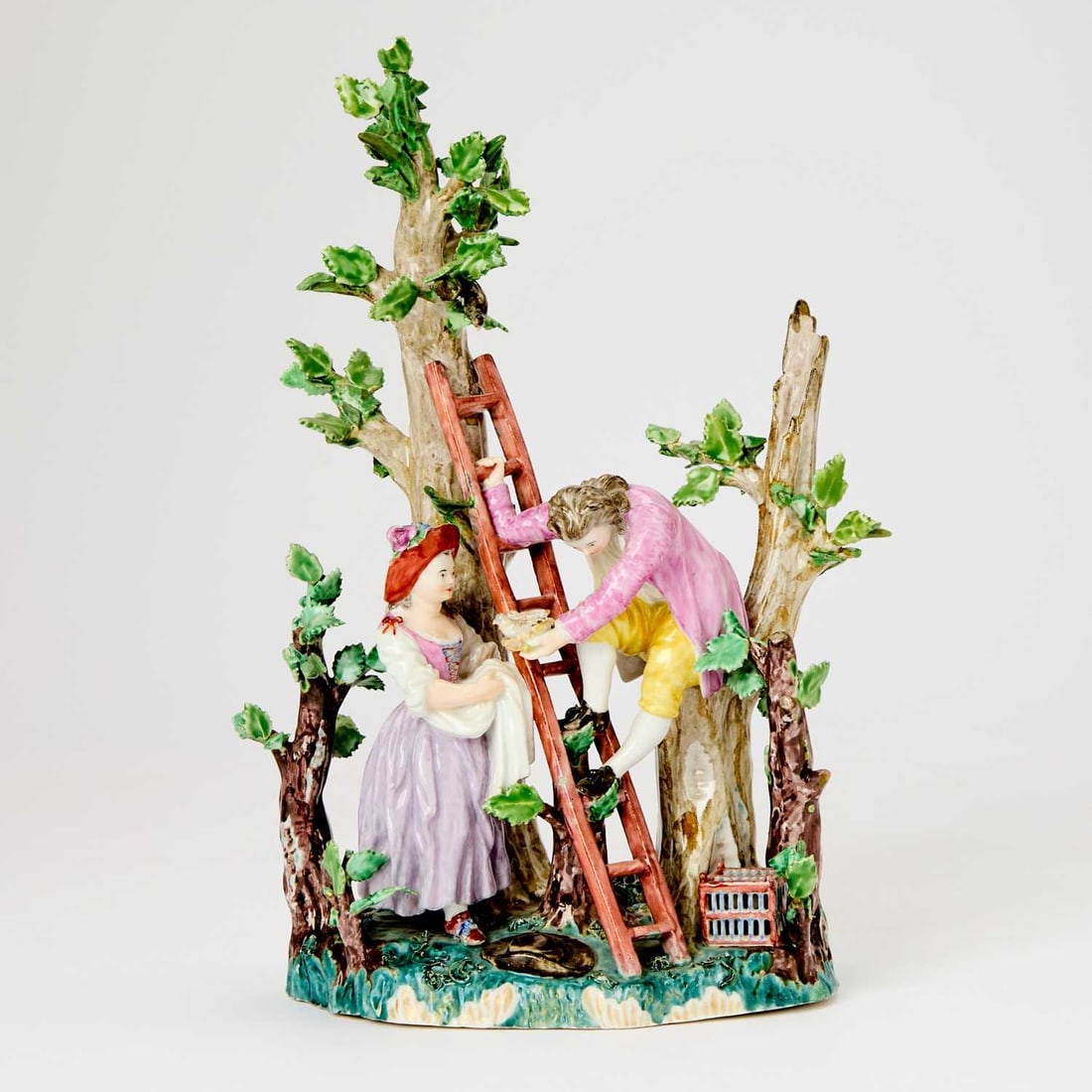 Volkstedt Porcelain Group of Bird Nesters Emblematic of 'Air': Circa 1770-1775 Modeled as a pastoral couple, he climbing down from a tree to present his lover with a young bird. Height 11 inches (27.9 cm). Provenance: Daniela Kumpf Kunshandel, Wiesbaden.