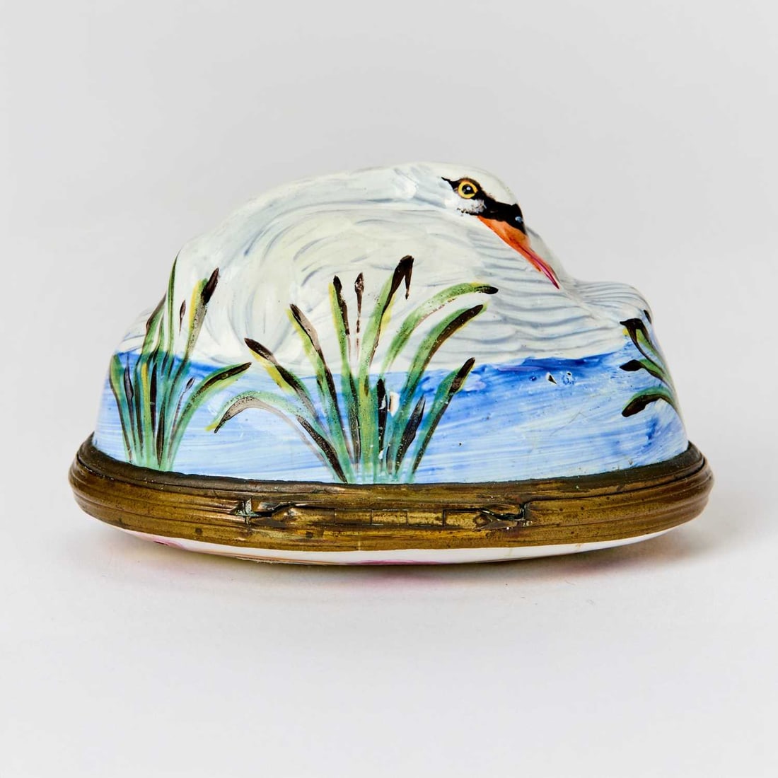 South Staffordshire Copper-Mounted Enamel Snuff Box: Circa 1775-1780 The hinged top molded in the shape of a nesting swan above an oval painted medallion with two swans and tall grasses within a C-scroll border. Width 2 1/2 inches (6.4 cm).
