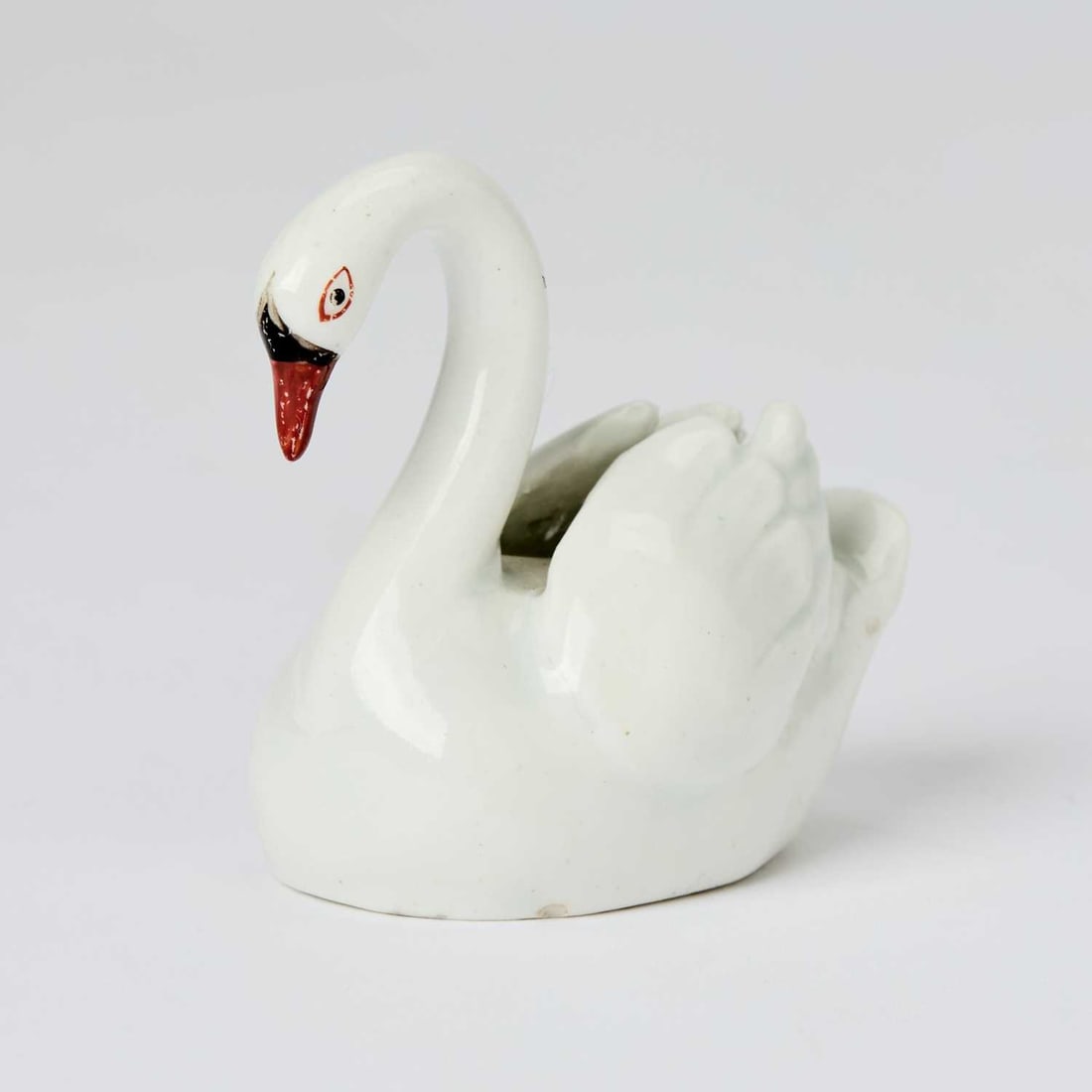 Lowestoft Porcelain Model of a Swan: Circa 1785 Realistically modeled with black and iron-red eyes and beak, the feathers incised. Height 2 1/2 inches (6.3 cm).