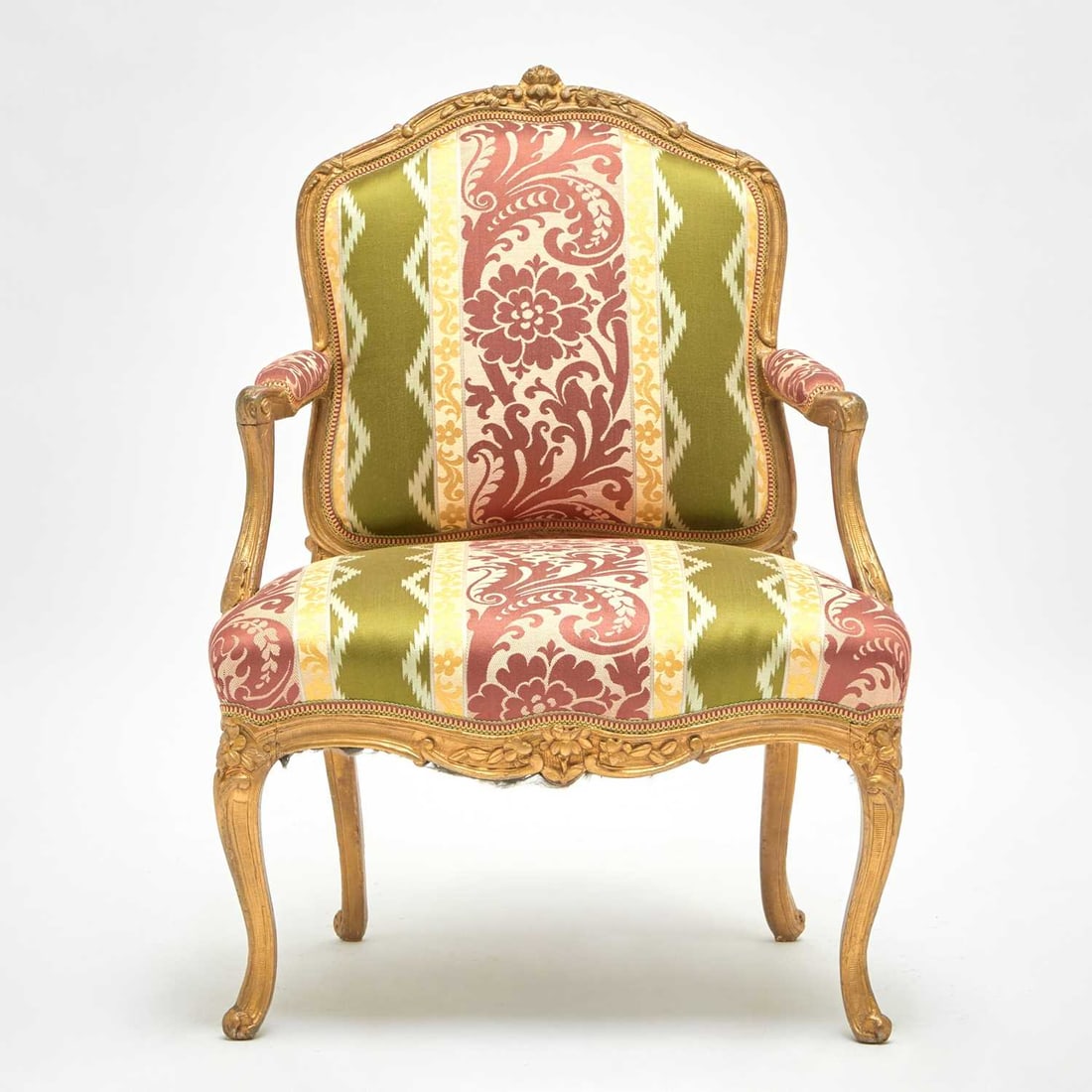 Louis XV Carved Giltwood Fauteuil à la Reine: Mid-18th century Height 37 inches (93.9 cm), width 27 inches (68.5 cm), depth 22 inches (55.8 cm). Provenance: Sotheby’s New York, March 24, 1994, lot 221.