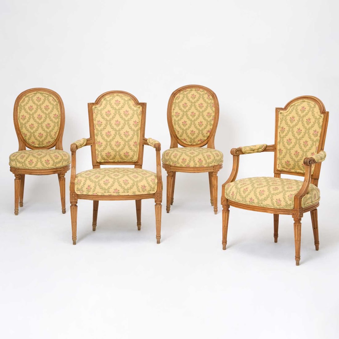 Assembled Set of Four Louis XVI Beechwood Fauteuils: Late 18th century Height 35 1/2 inches (90.1 cm), width 22 inches (55.8 cm), depth 16 3/4 inches (42.5 cm). Sunfading, perishing to varnish, old marks and scratches, please note that Doyle does