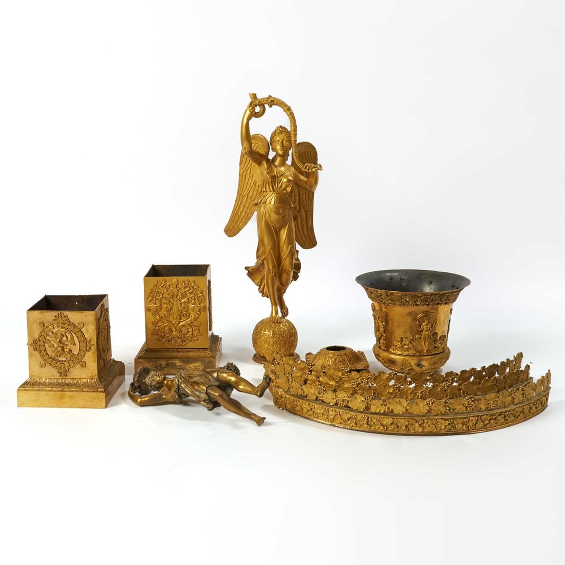 Collection of French Empire Ormolu Mounts: Early 19th Century Of different shapes and sizes, originally part of candelabra and a Medici form urn (incomplete). Please note, this lot is offered AS IS.