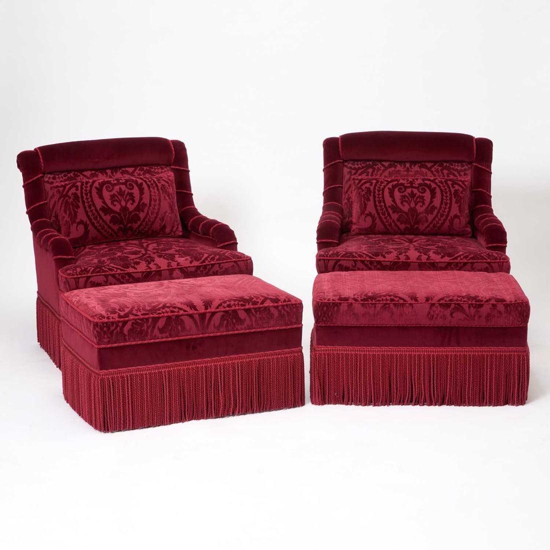 Pair of French Pierre Frey Red Velvet Upholstered Swivel Club Chairs: Late 20th/early 21st Century Each with matching ottomans. Chair height 30 1/2 inches (77.4 cm), width 30 inches (76.2 cm), depth 22 3/4 inches (57.8 cm); ottoman height 15 inches (39.4 cm), width 30 i