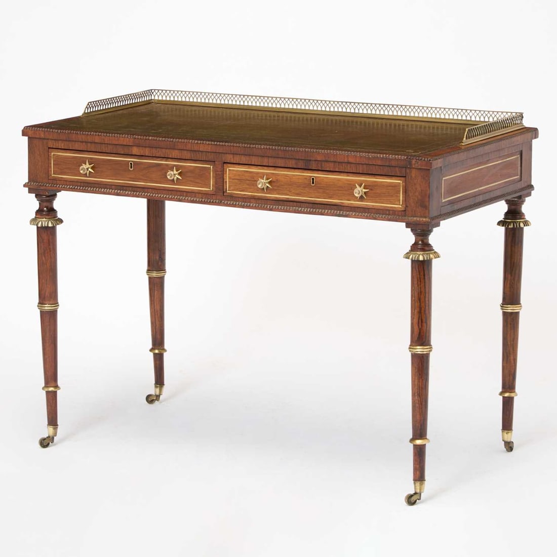 Regency Brass-Mounted Rosewood Writing Table: Attributed to John McClean With three quarter brass gallery Height 30 1/2 inches (67 cm), width 40 1/2 inches (103 cm), depth 21 1/2 inches (54.5 cm).