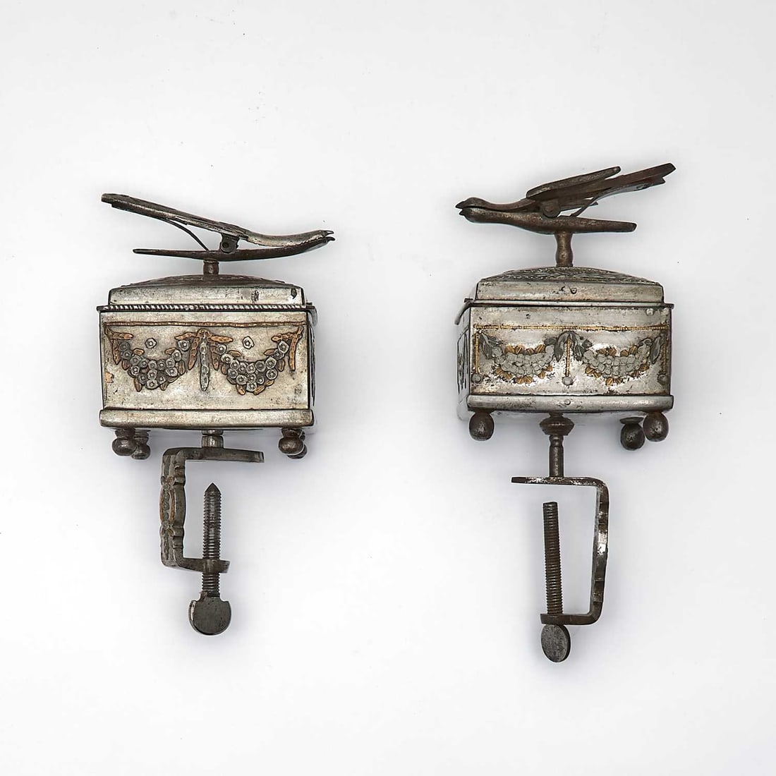 Two Russian Tula Steel Parcel-Gilt Sewing Boxes and Covers: One by T.I. Svechnin, Tula, Mid-19th Century The rectangular bodies applied with festoons of floral garlands, the covers surmounted by a stylized bird-form finial, the interiors fitted for sewing impl