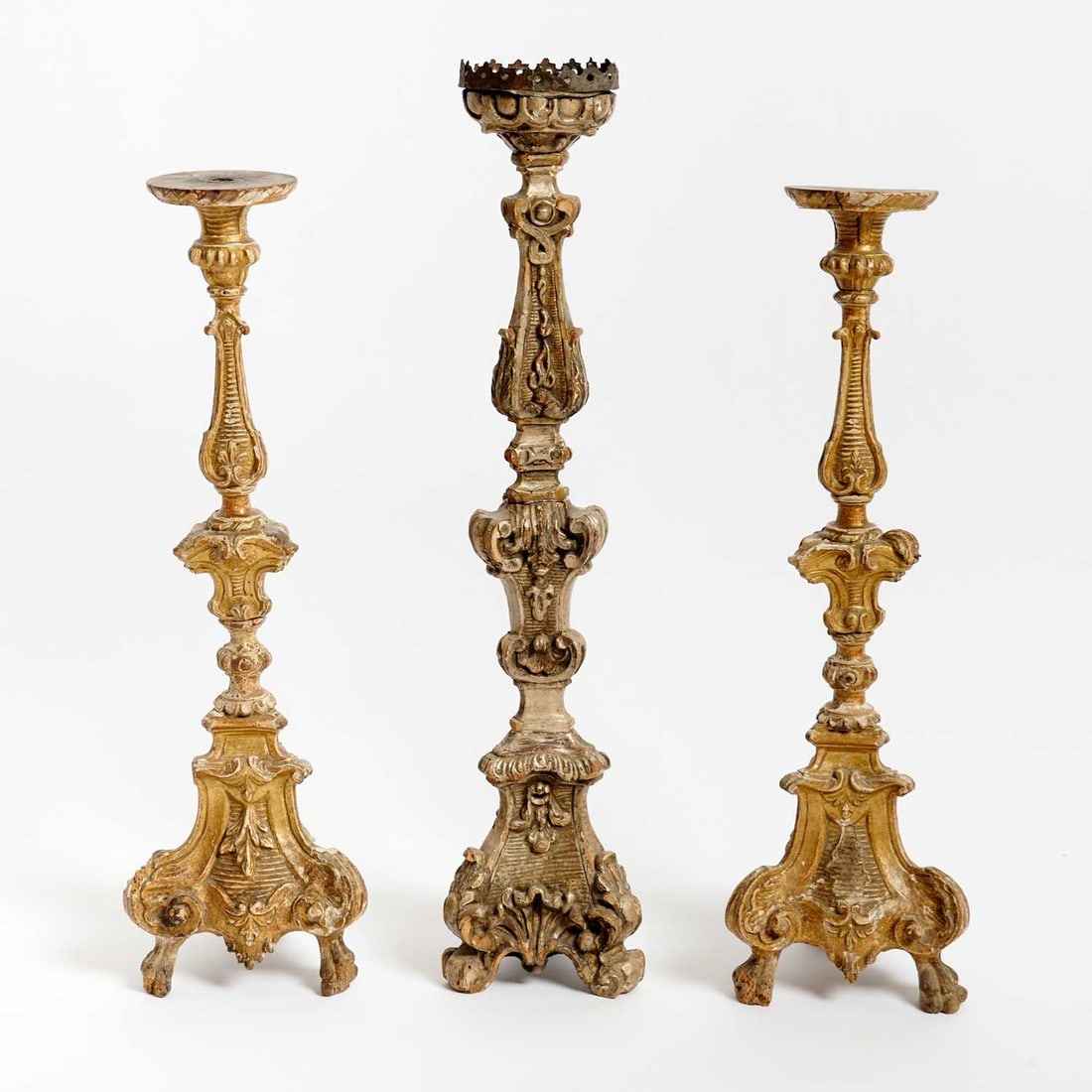Three Italian Baroque Painted and Carved Wood Candlesticks: Mid-18th Century Each with molded collar above a tapering baluster shaft carved with acanthus and stylized leaf ornament, set on supports carved in relief. Height 27 inches (68.5 cm), 31 1/4 inches (7