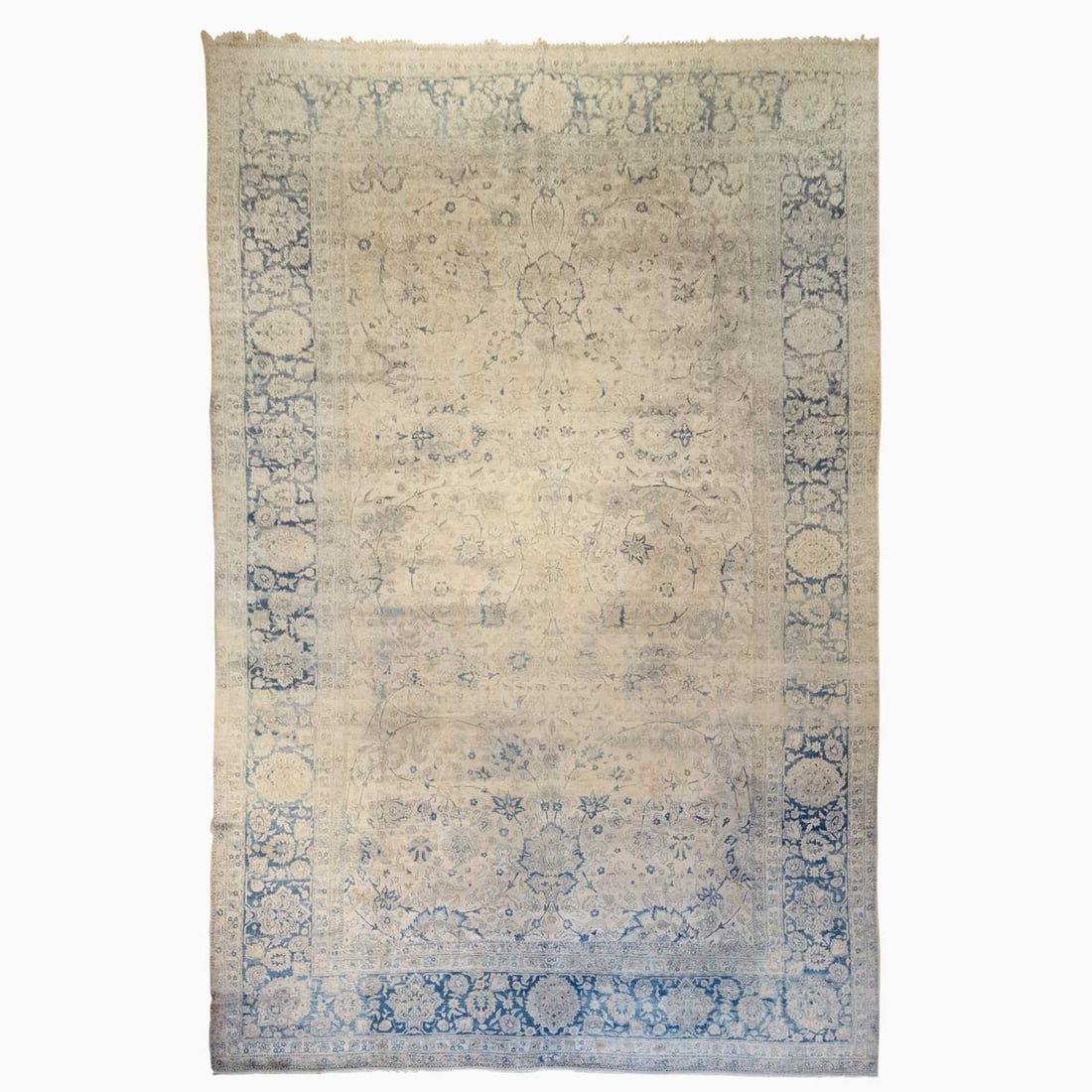 Kerman Carpet: Southeast Persia, First 1/4 20th Century The buff field with a 16th century Isfahan pattern of large-scale palmettes amongst cloud bands is within an indigo palmette and vine border. (22' 7" x 13' 5")