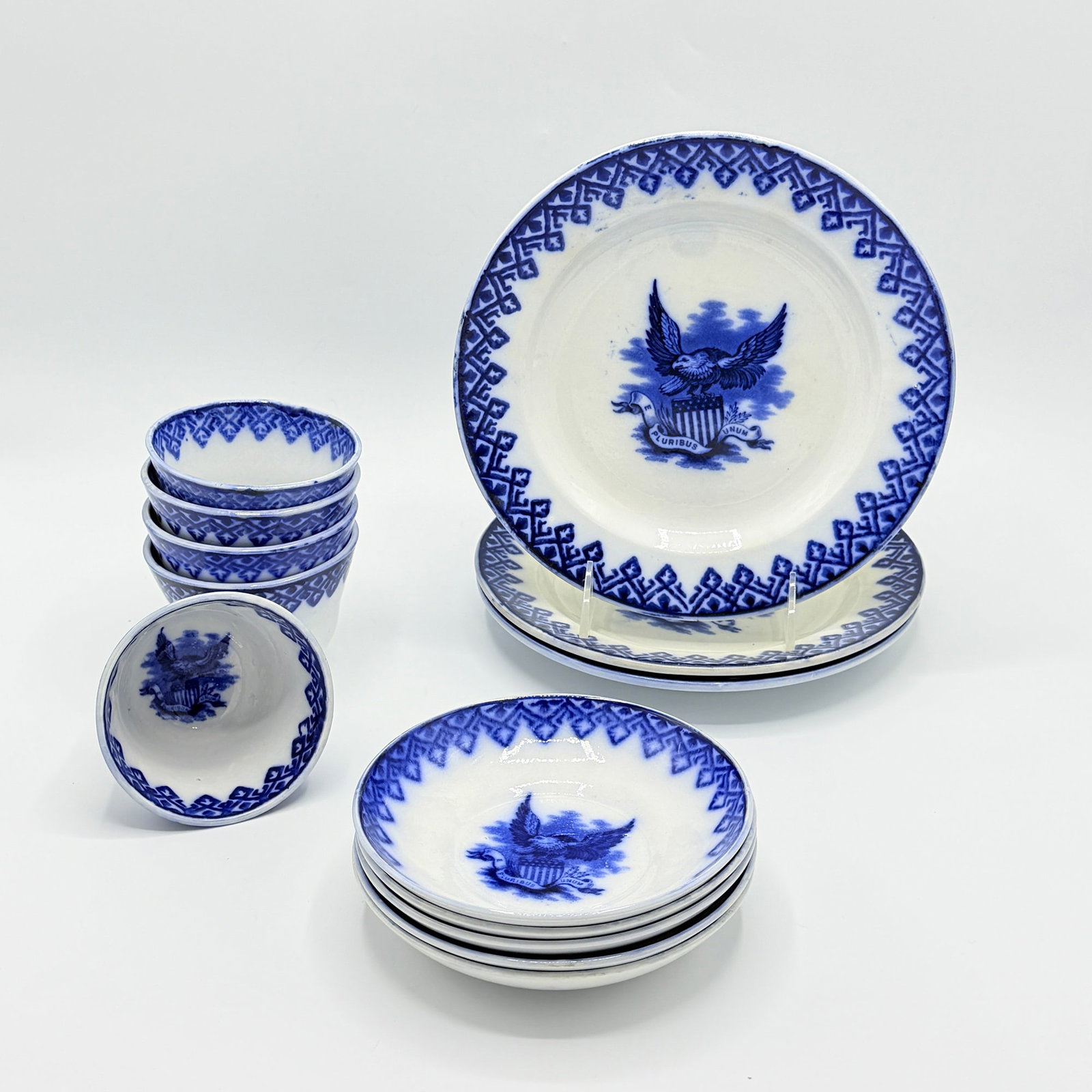 Group of Hammersley Eagle Blue Transfer Decorated Porcelain Table Articles: Late 19th century Comprising three luncheon plates, five handleless teacups, and five saucers, each with stick spatter rim centering an eagle above the Union shield Diameter of luncheon plate 8 3/4