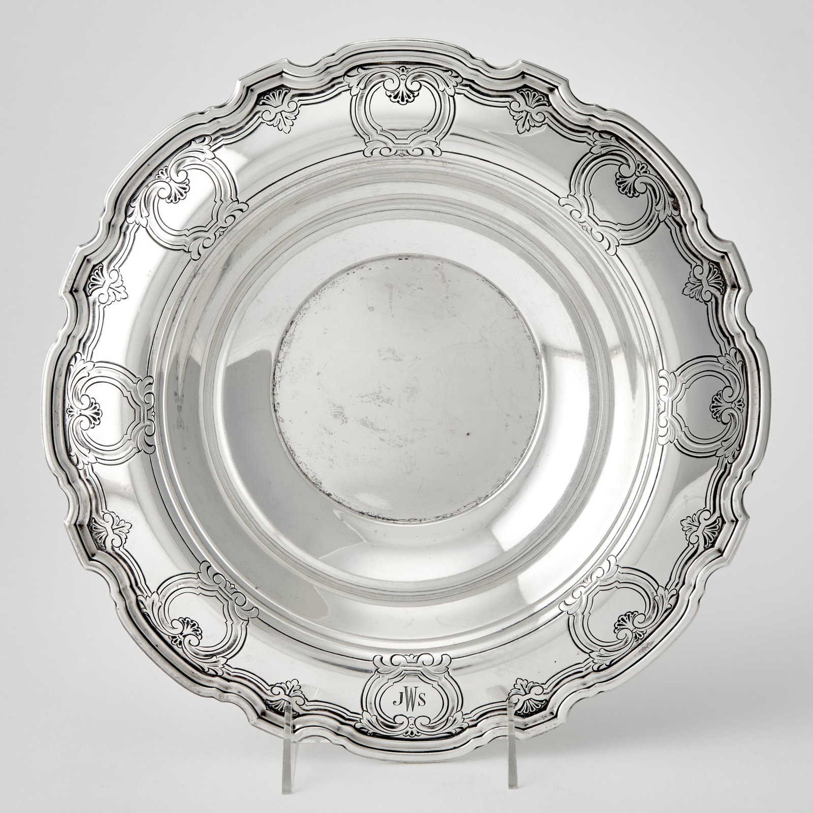 Tiffany & Co. Sterling Silver Centerpiece Bowl: 1907-1938 Shaped circular, the notched everted rim with stylized scrolls and shells. Height 2 1/2 inches, diameter 12 inches, approximately 25 ounces.