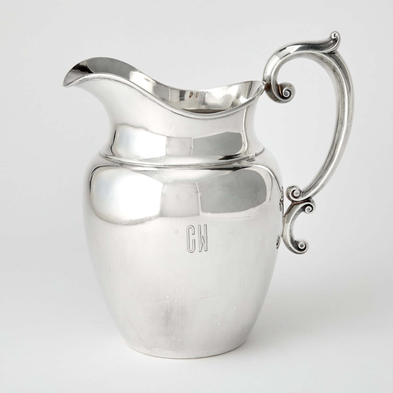 Gorham Sterling Silver Water Pitcher: Mid 20th century The ovoid body with scrolling handle. Height 8 3/4 inches, approximately 19 ounces.
