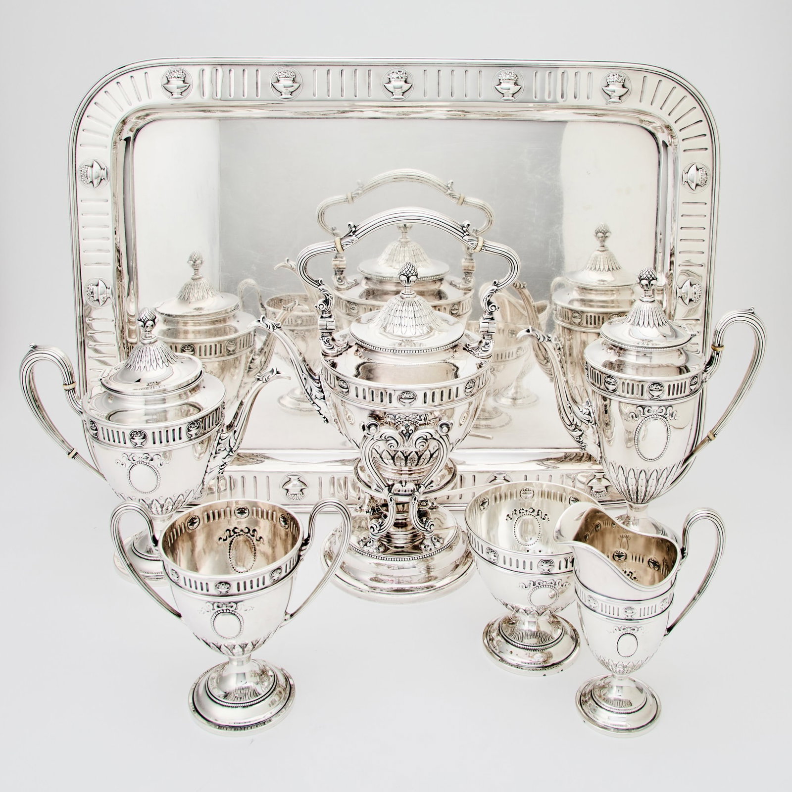 Theodore B. Starr Sterling Silver Tea and Coffee Service with Tray: First half 20th century In the neoclassical style, each vasiform with band of acanthus leaves to body, comprising a teapot, coffee pot, height 11 1/2 inches, cream jug, covered sugar bowl, waste bowl,