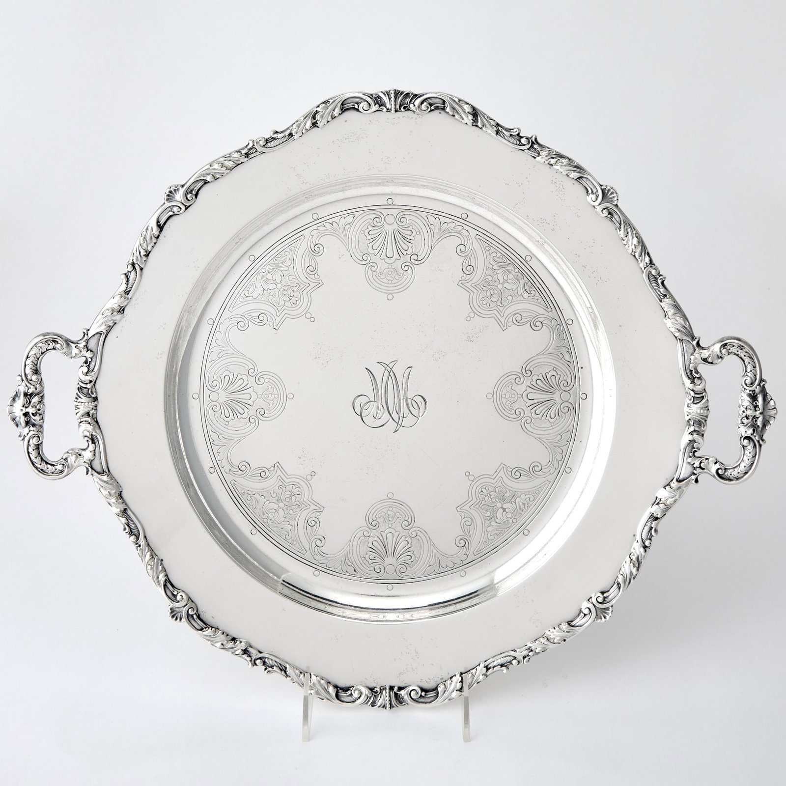 Gorham Sterling Silver Two Handled Tray: Retailed by Spaulding & Co., Chicago, 20th century Shaped circular with applied foliate scroll border, with loop handles. Length over handles 18 inches, approximately 46 ounces.