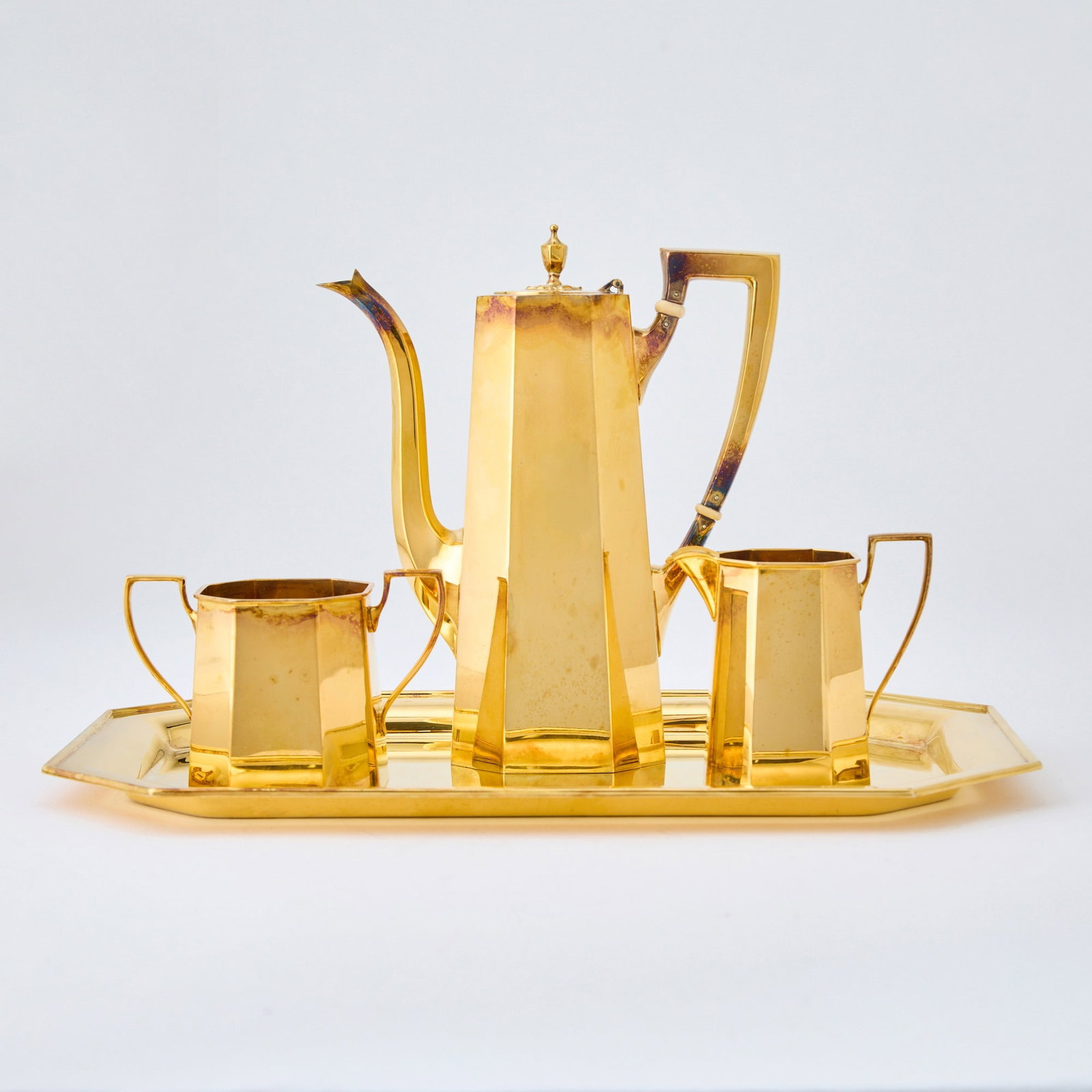 Tiffany & Co Sterling Silver Gilt Demitasse Coffee Service: Second half 20th century Comprising a coffee pot, height 7 1/2 inches, cream jug, sugar bowl and tray, length 13 1/2 inches, total approximately 44 ounces, all in.