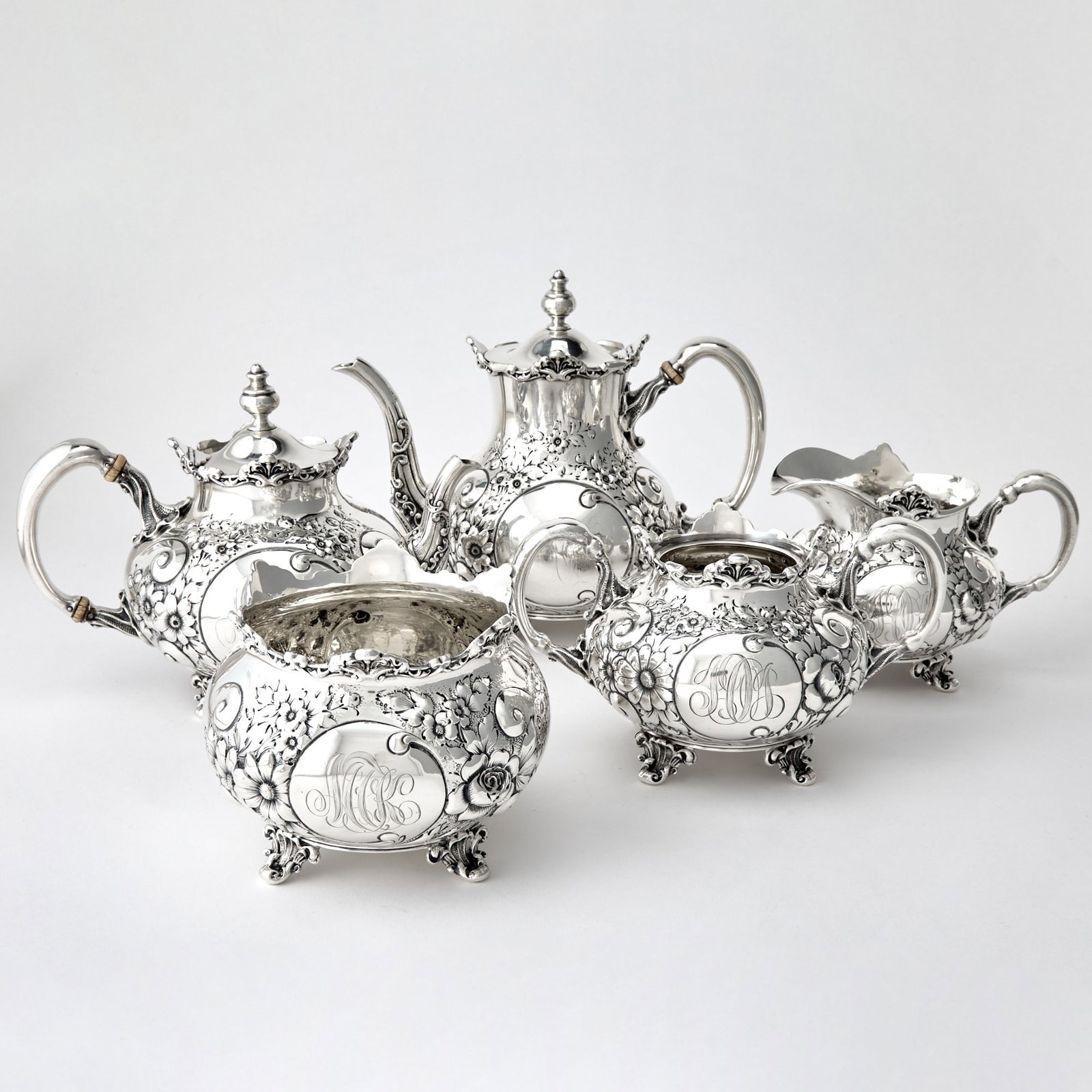 Mauser Sterling Silver Tea and Coffee Service: Early 20th century Comprising a teapot, coffee pot, height 7 3/4 inches, cream jug, sugar bowl and a waste bowl. Total approximately 90 ounces, all in.
