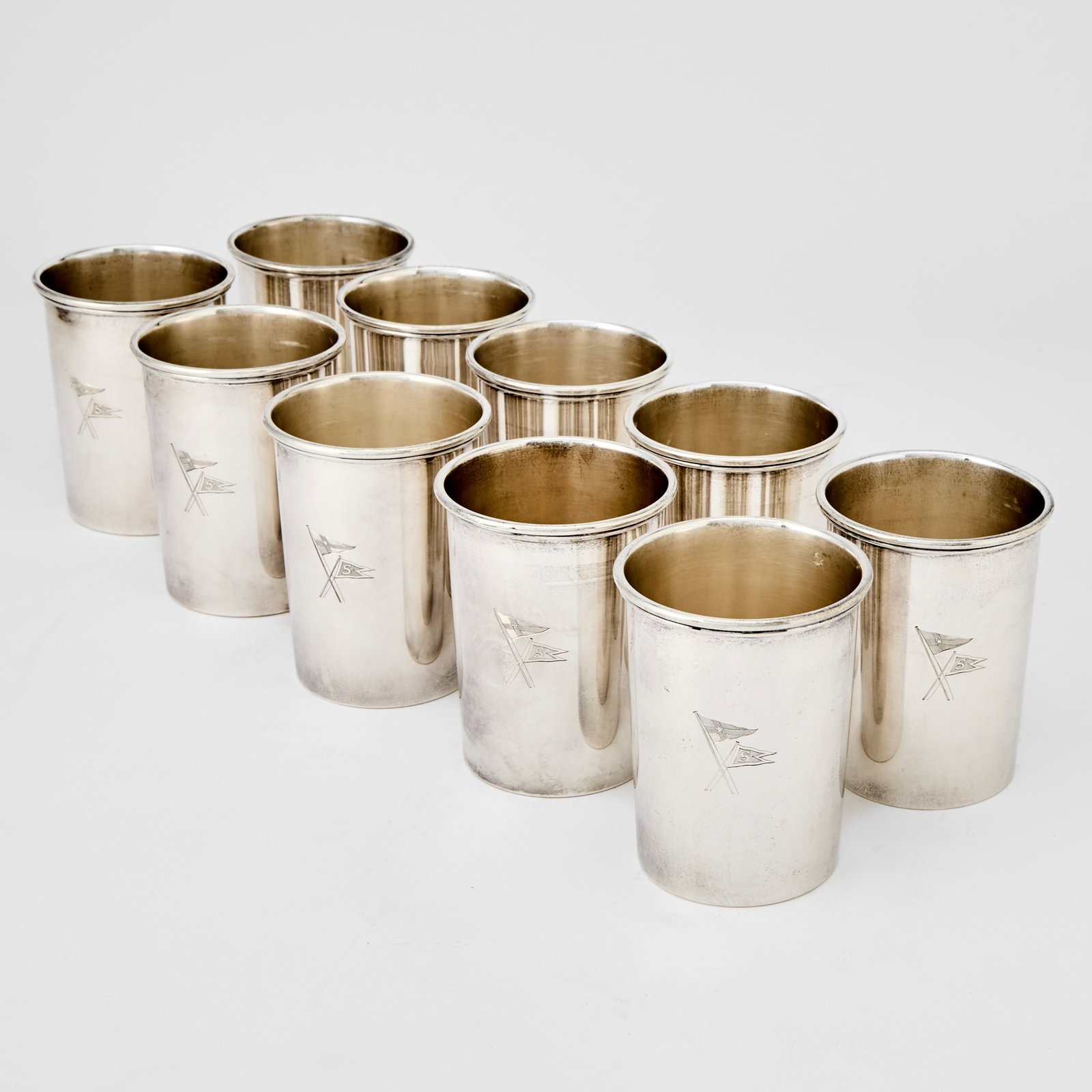 Yachting Interest: Set of Ten American Sterling Silver Julep Cups: Richard Woods & Co., New York, 1910s/1920s Each cylindrical, engraved with yacht burgees for The New York Yacht Club and Thomas Slocum's yacht Ranger. Height 4 inches, total approximately 50