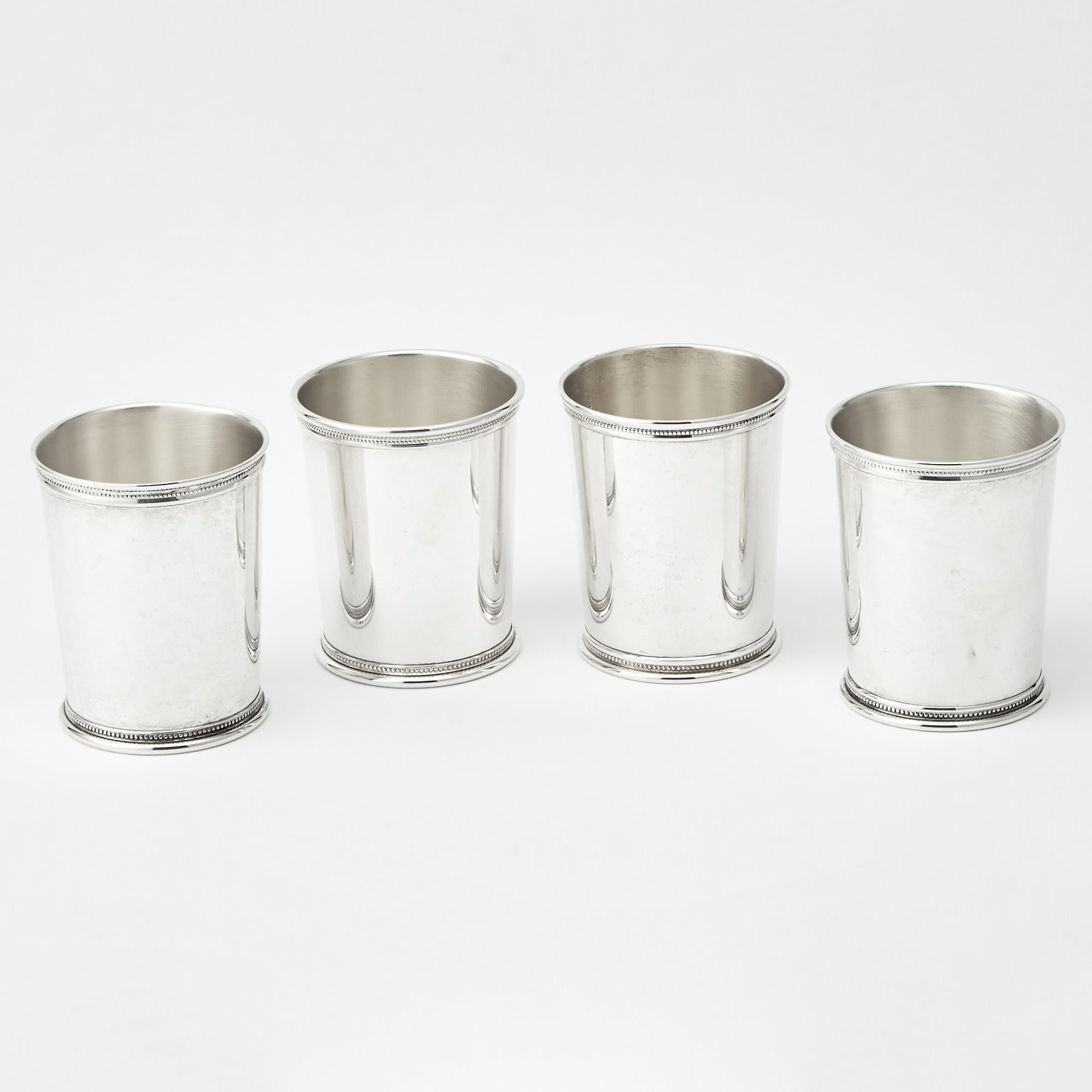 Four American Sterling Silver Julep Cups: Mark J. Scearce, late 20th century Each cylindrical with rope twist border. Height 3 3/4 inches, total approximately 21 ounces. Qty: (4)