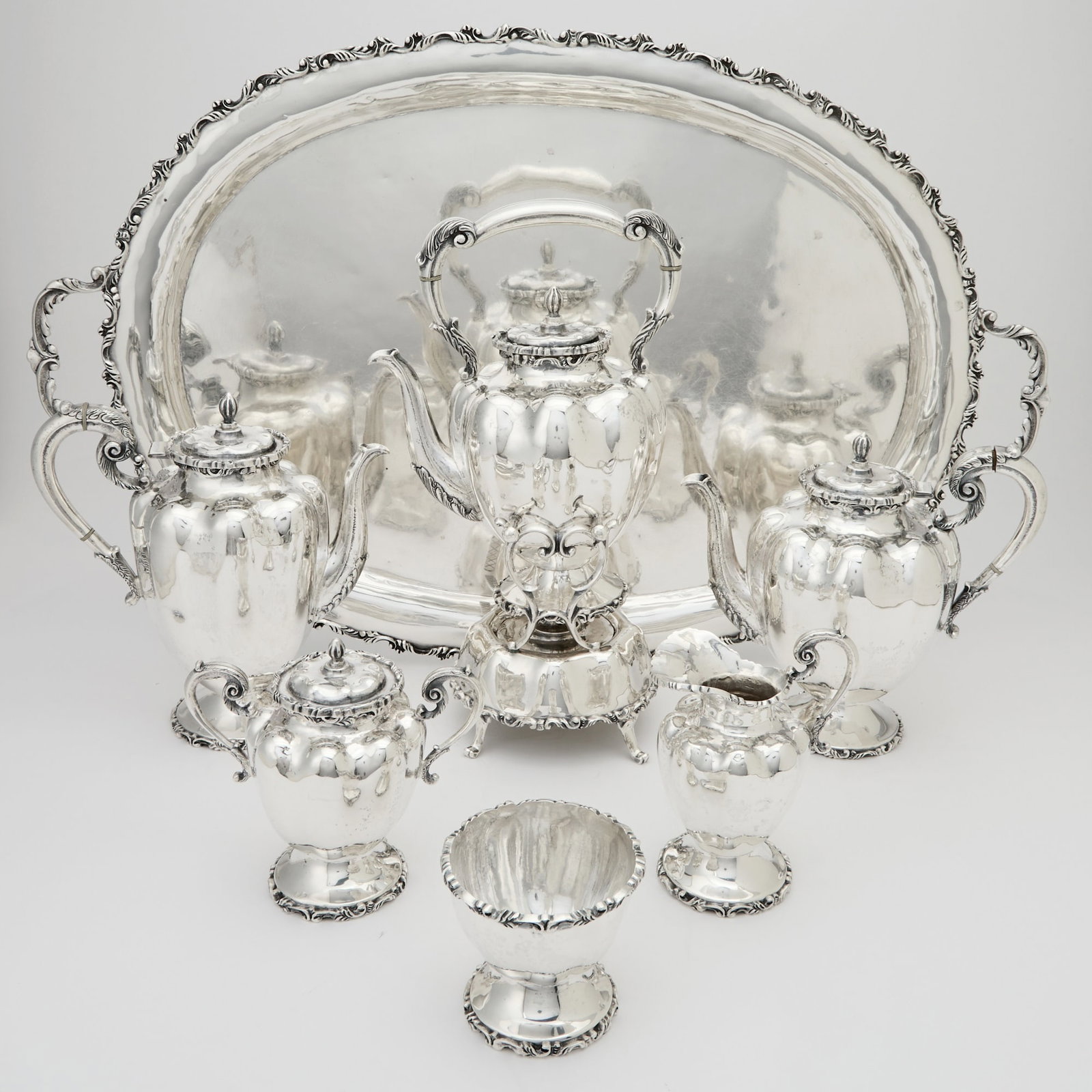 Mexican Sterling Silver Tea and Coffee Service: Topez, Taxco, mid 20th century Comprising a teapot, coffee pot, height 9 inches, cream jug, covered sugar bowl, waste bowl, kettle-on-stand and two handled tray, length over handles 29 inches, total