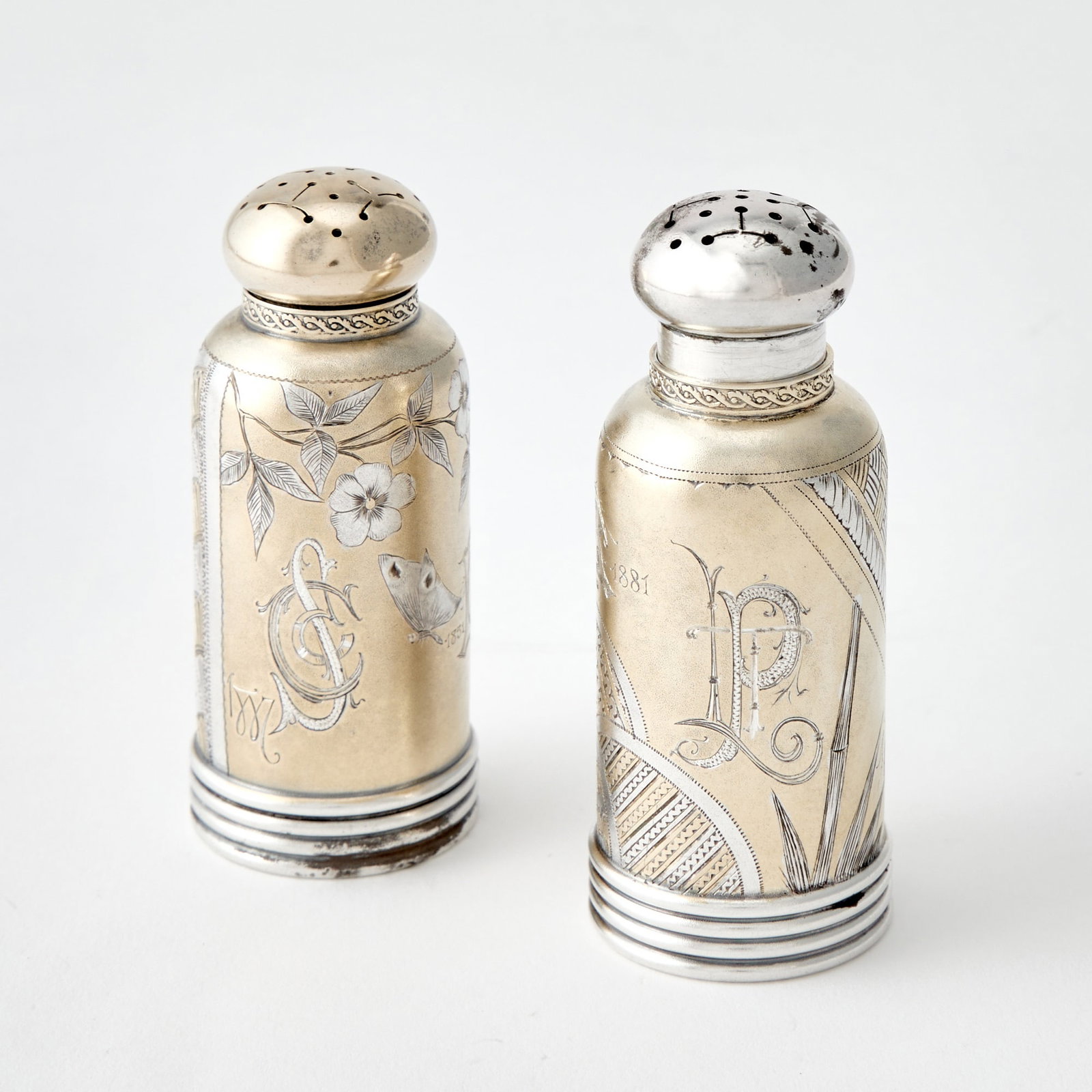 Pair of Gorham Aesthetic Movement Sterling Silver and Gilt Salt and Pepper Casters: 1880s Each cylindrical with engraved Japanesque decoration. Height 3 1/4 inches, total approximately 2 ounces.