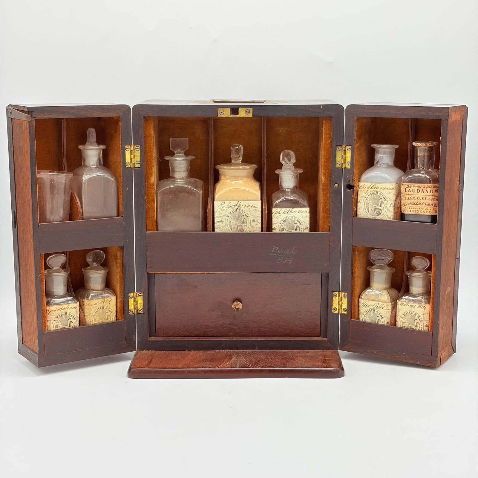 Mahogany Cased Medicine Set: Mid to late 19th century Two hinged doors opening to reveal a drawer and fitted compartments. Height 10 1/4 inches, width 8 1/4 inches, depth 7 1/4 inches