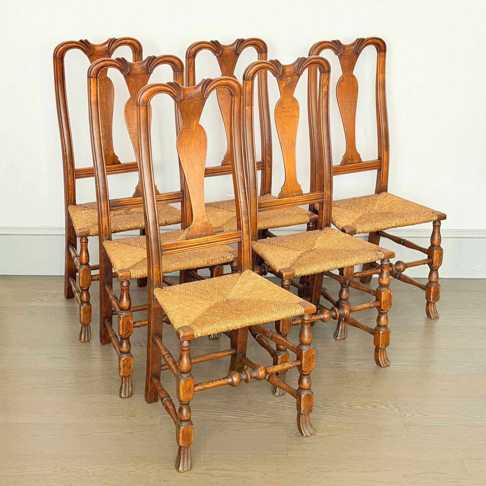 Set of Six Queen Anne Maple Rush-seat Side Chairs: Portsmouth, New Hampshire, circa 1740 Each with spooned crestrails above vasiform splats, raised on block-, vase-, and ring-turned legs ending in Spanish feet.| Height 42 inches Provenance: Hollis Bro