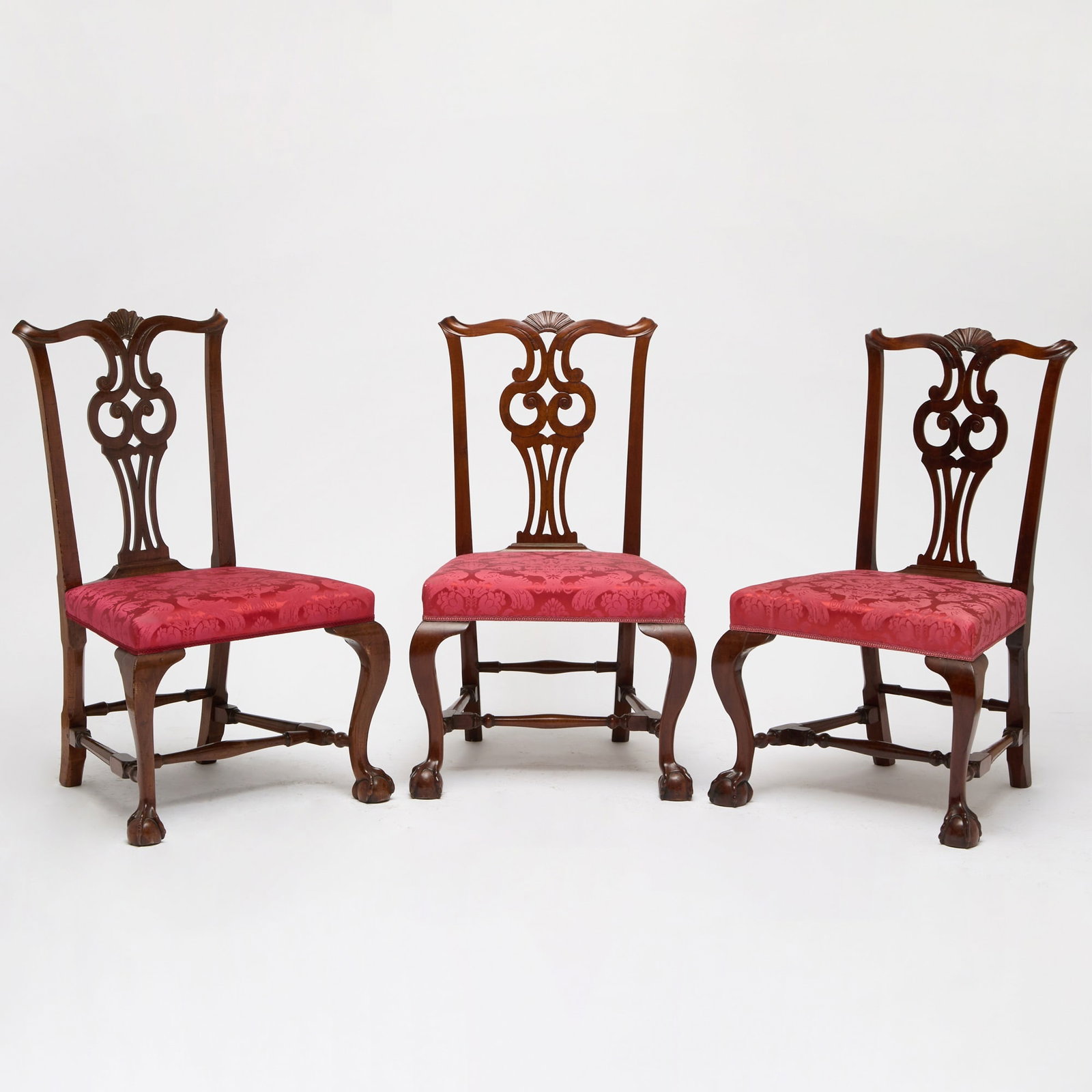 Assembled Set of Three Chippendale Mahogany Side Chairs: Boston, Massachusetts, circa 1770 Each with serpentine crest with molded terminals centering a shell above pierced and scroll-carved owl splat, above overupholstered seat joining frontal cabriole