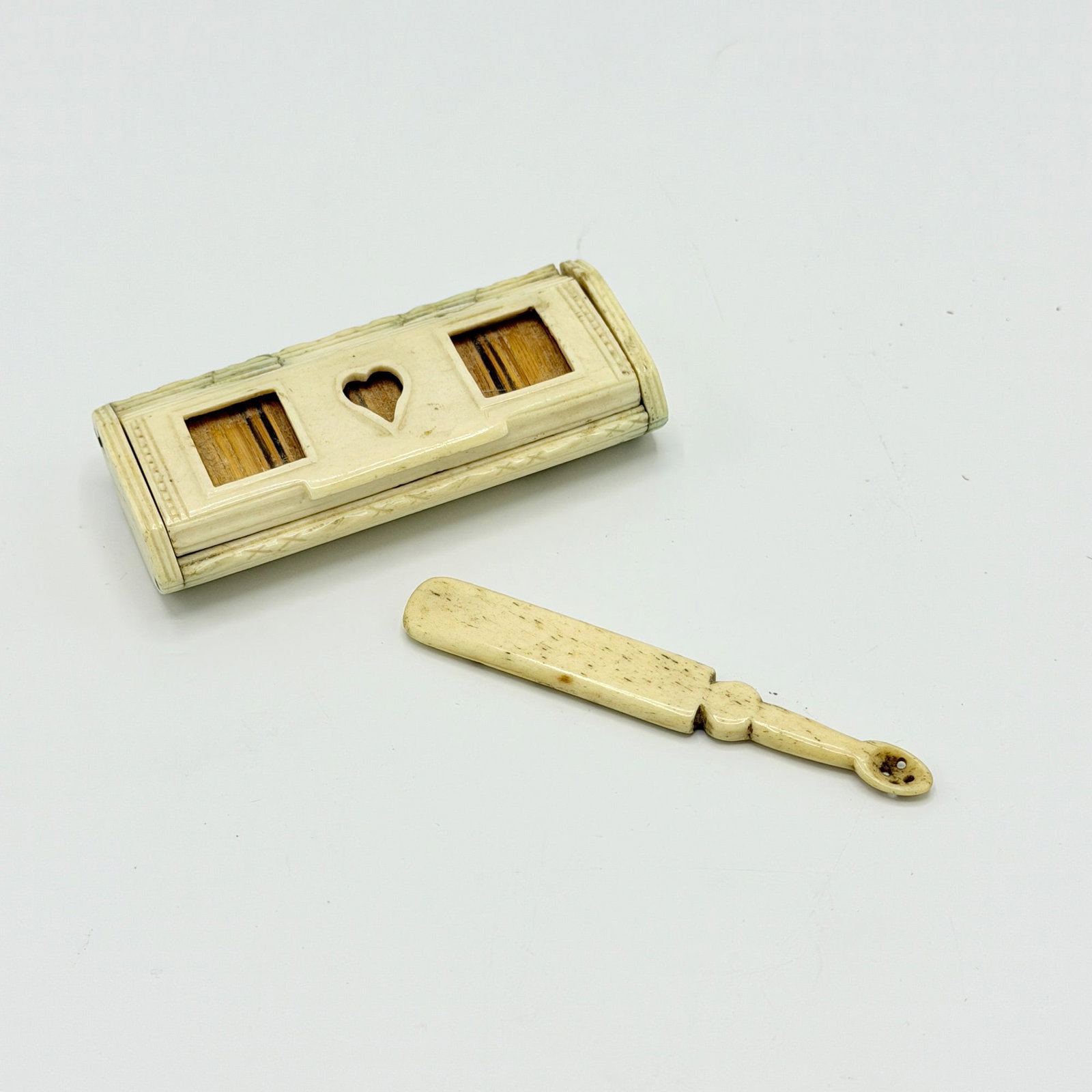 Bone Snuff Box and Spoon: America or England, early 19th century The hinged snuff box lid pierced with a heart and rectangles. Length of box 3 1/2 inches. Provenance: The Lloyd Collection sale, August 7, 1988, Kennebunk, Maine