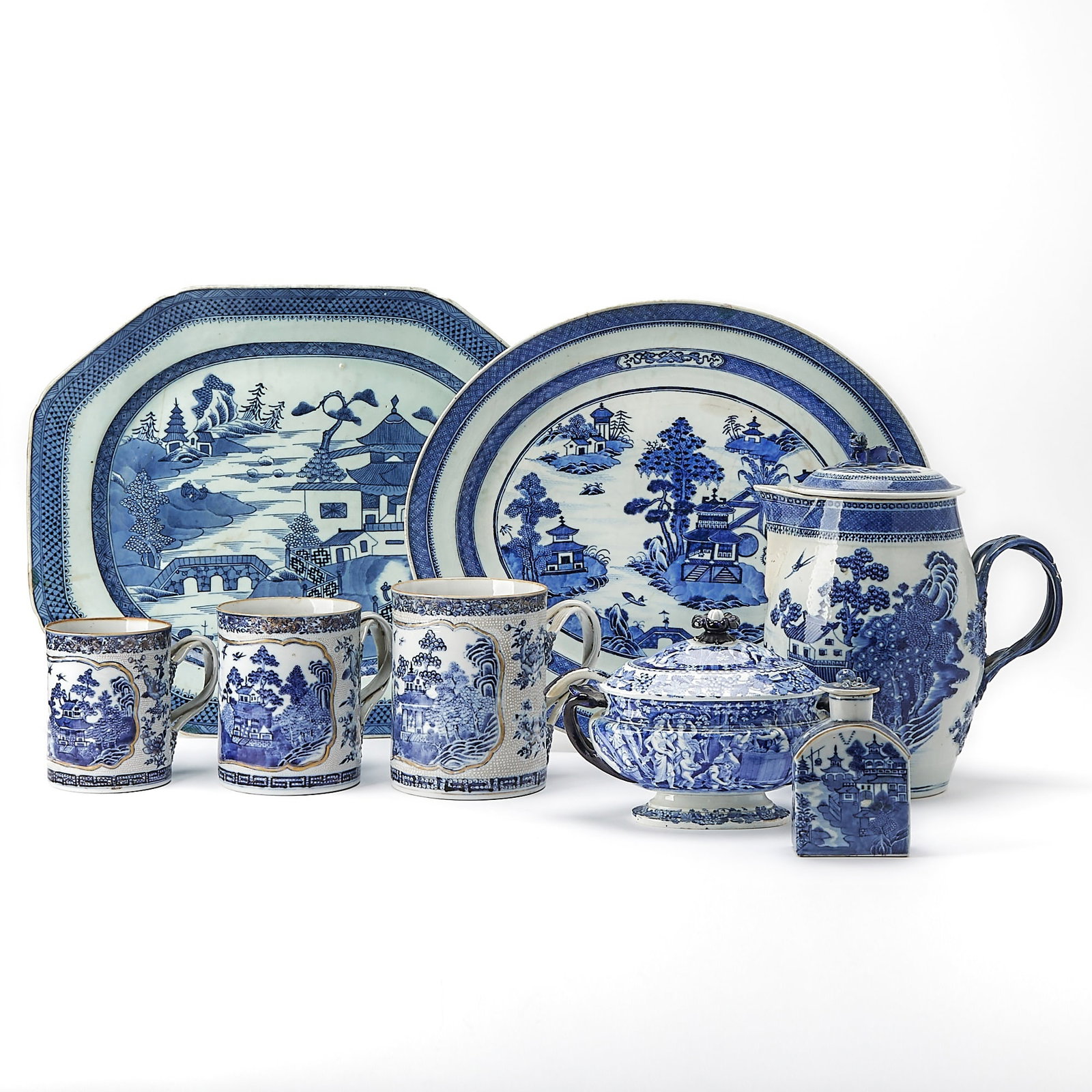 Group of Chinese Export Blue and White Porcelain: 19th century Comprising a covered cider jug height 11 inches, a set of three graduated mugs with landscape cartouches, a tea caddy, an octagonal platter length 18 3/4 inches, and an oval platter lengt