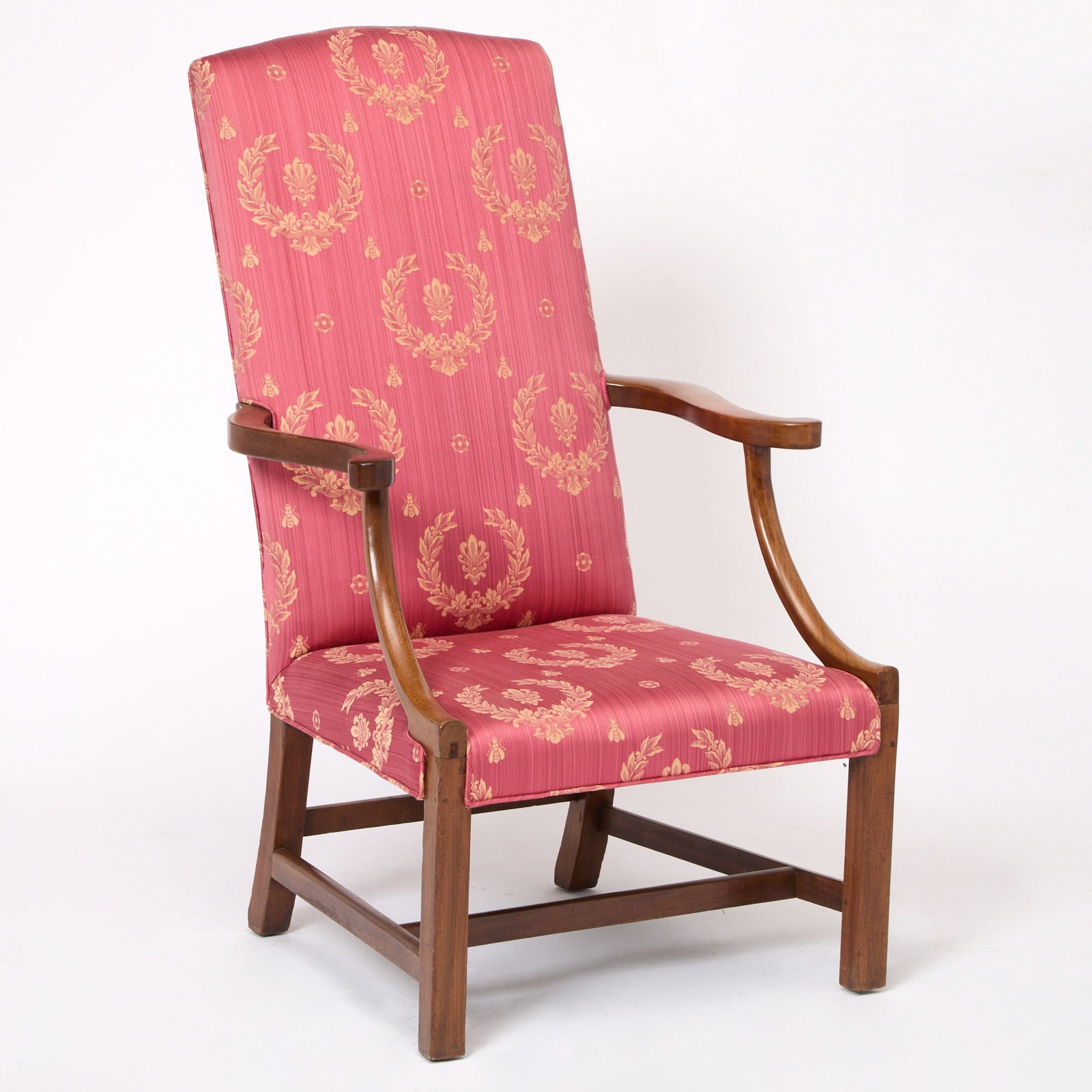 Chippendale Mahogany Lolling Chair: Massachusetts, circa 1790 The slightly arched crest above outward-scrolling arms on concave supports and square front legs joined by H-stretcher. Height 44 inches, seat height 15 inches.