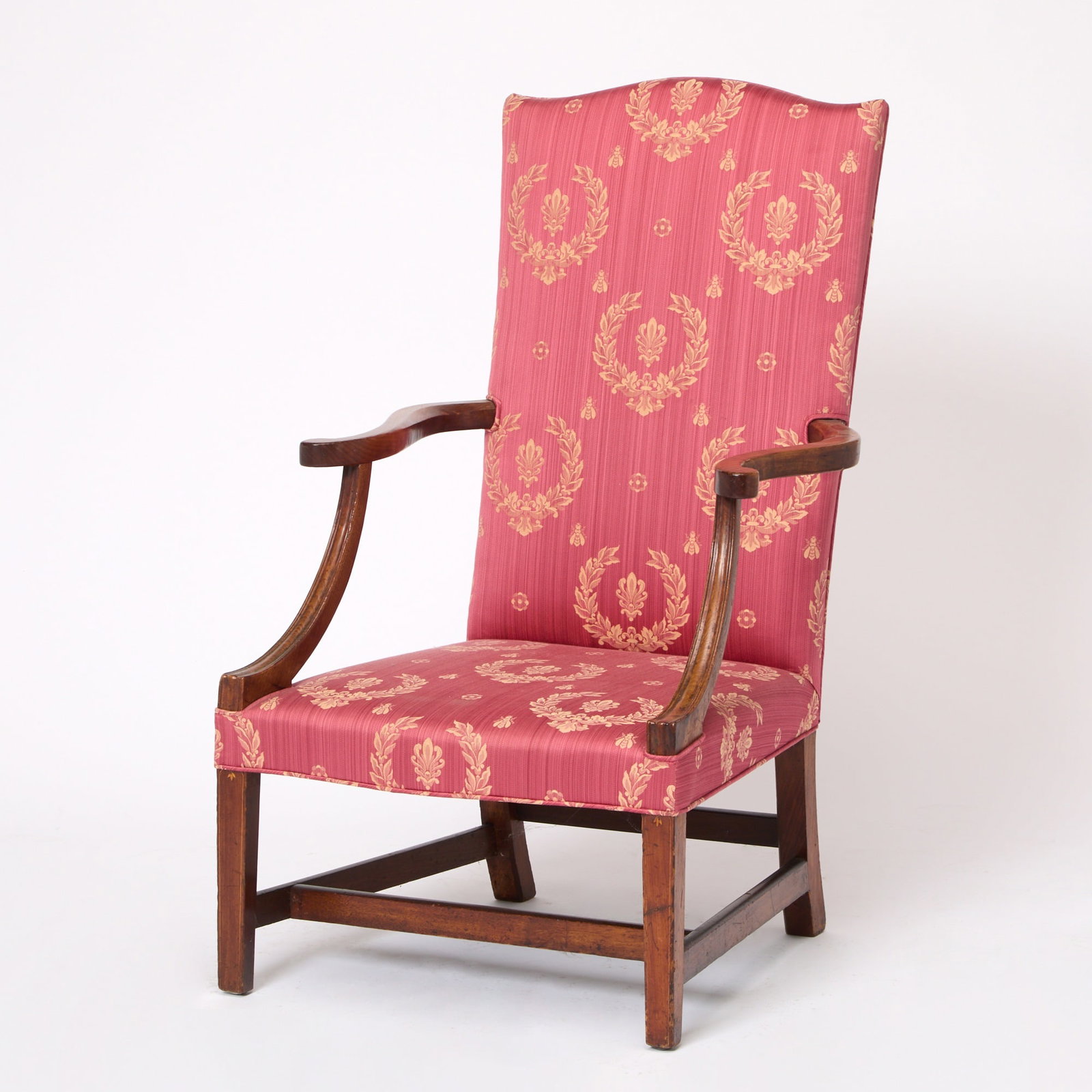 Chippendale Walnut Lolling Chair: Massachusetts, circa 1790 With serpentine crest above scrolled arms and molded concave supports, the serpentine front rail joining square slightly tapered string-inlaid legs joined by stretchers.