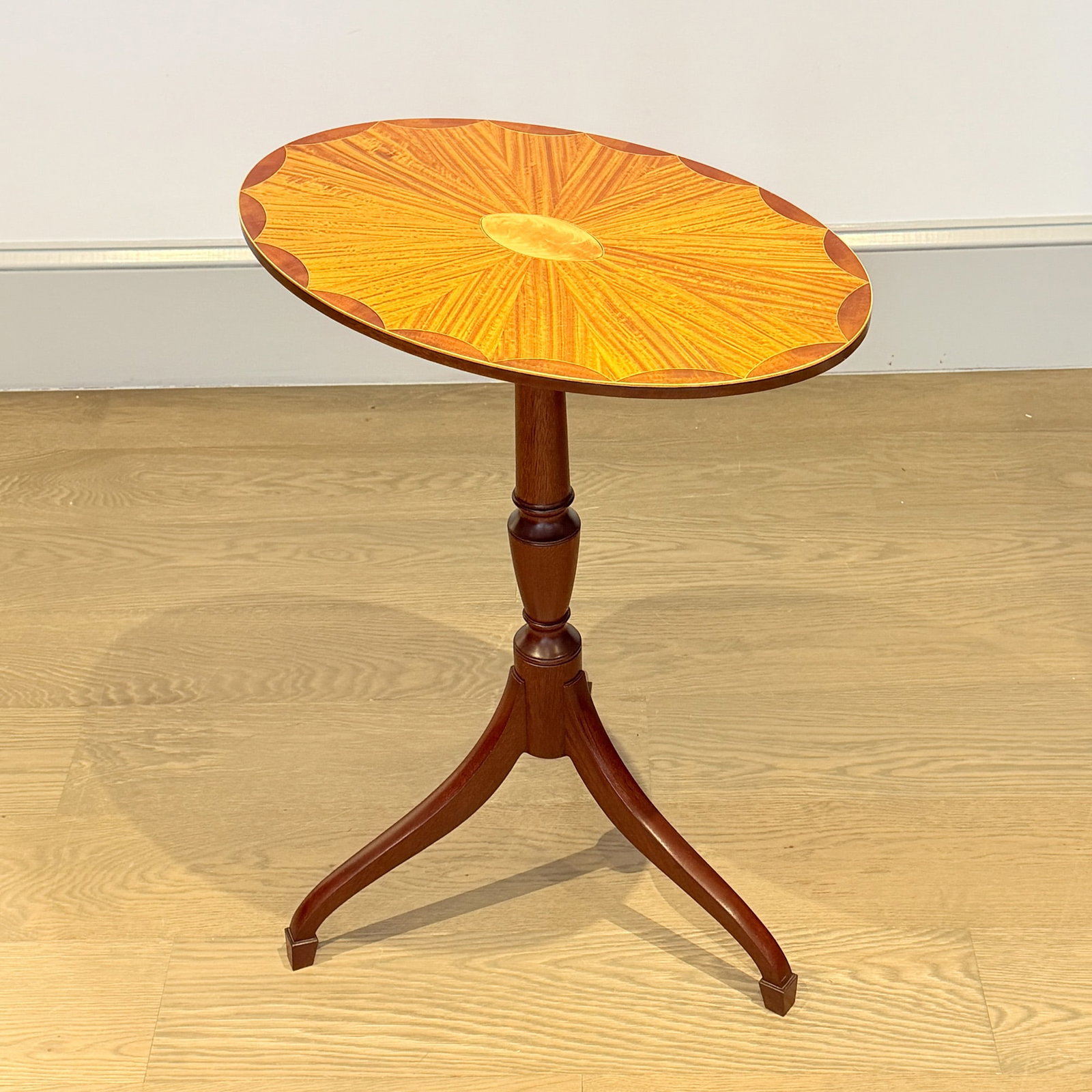 Federal Style Inlaid Mahogany Candlestand: Probably Bruce Eaton, Boxford, Massachusetts, dated 2006 The oval top with inlaid scalloped border surrounding radiating veneers and centering an oval, on a turned post continuing to tripod base of ta