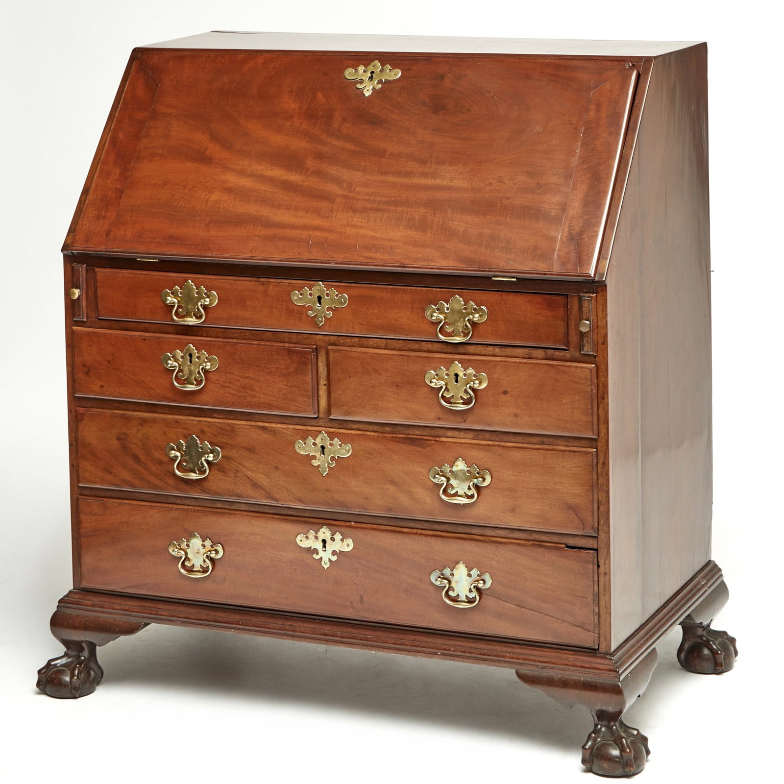 Chippendale Mahogany Slant-lid Desk: New York, circa 1760-80 The lid with notched corners opens to an interior centering an arched prospect door flanked by document drawers and valanced compartments with scrolled dividers, above pairs