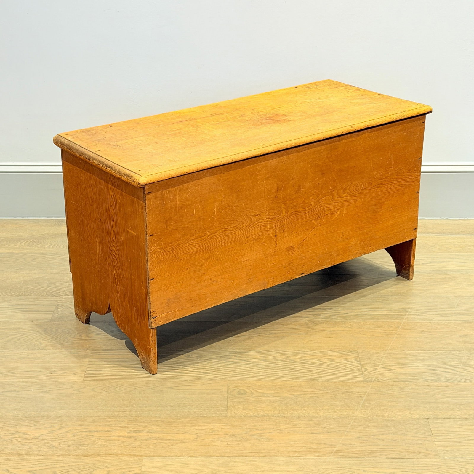 Pine Six Board Chest: Probably New Hampshire, late 18th century The molded top above cutout sides, in original natural surface, with original snipe hinges. Height 24 inches, width 43 inches, depth 19 inches Provenance:
