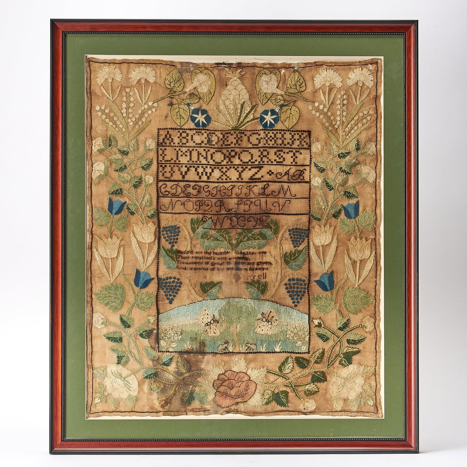 Needlework Sampler: New England, early 19th century Worked in silk threads on a coarse linen ground, composed of an elaborate flower border of lilies-of-the-valley, morning glories, tulips, and roses, centering alphanume